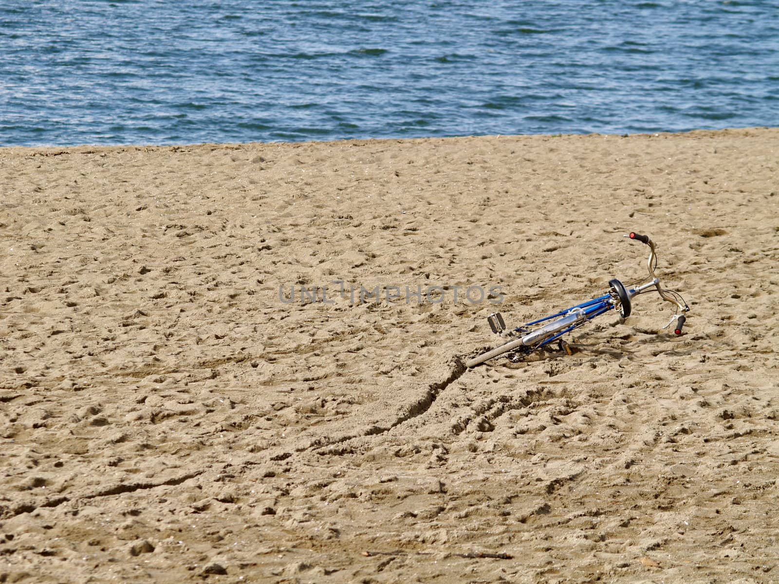 Bicycle in the sand at the sea