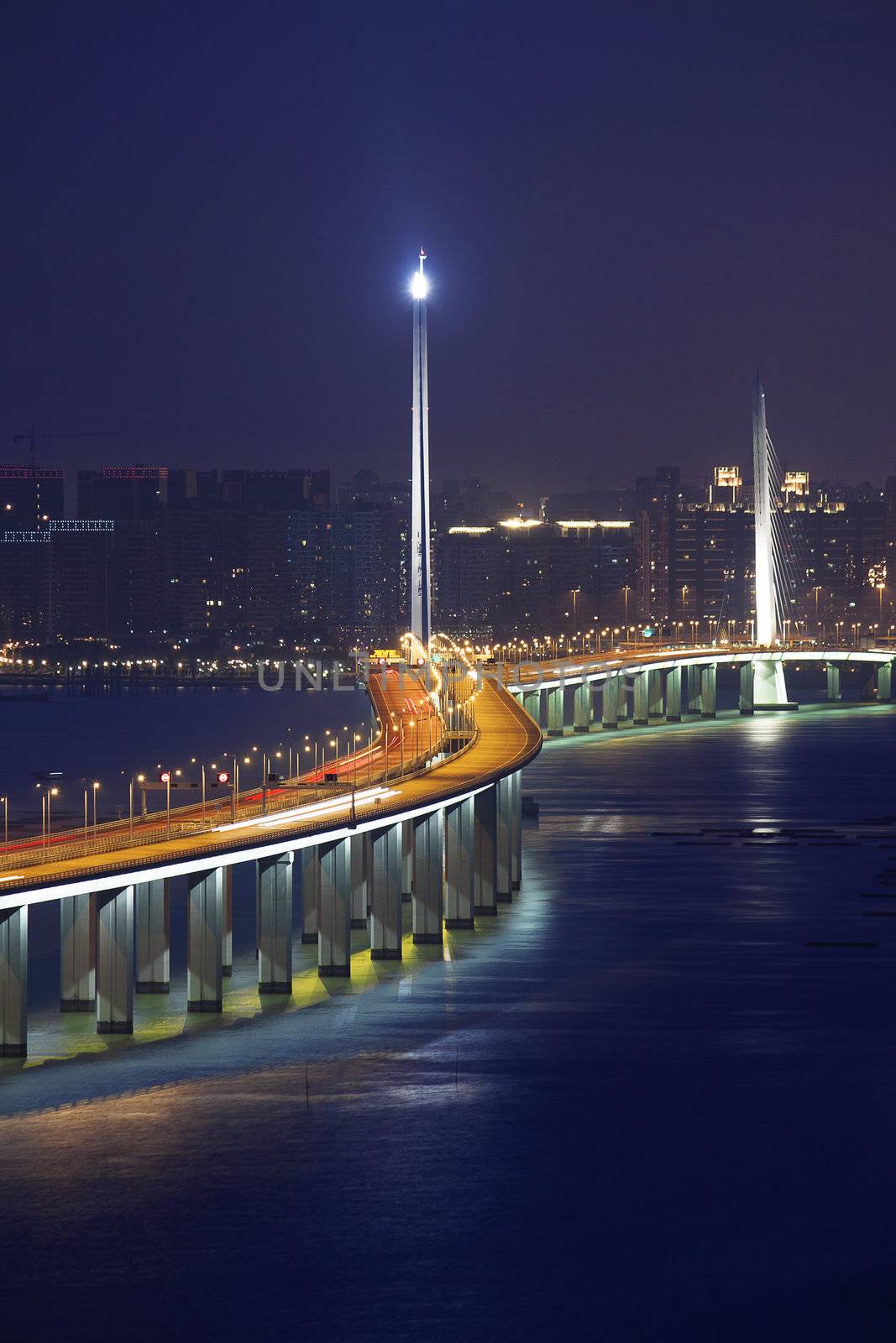 Freeway in night with cars light in modern city. 