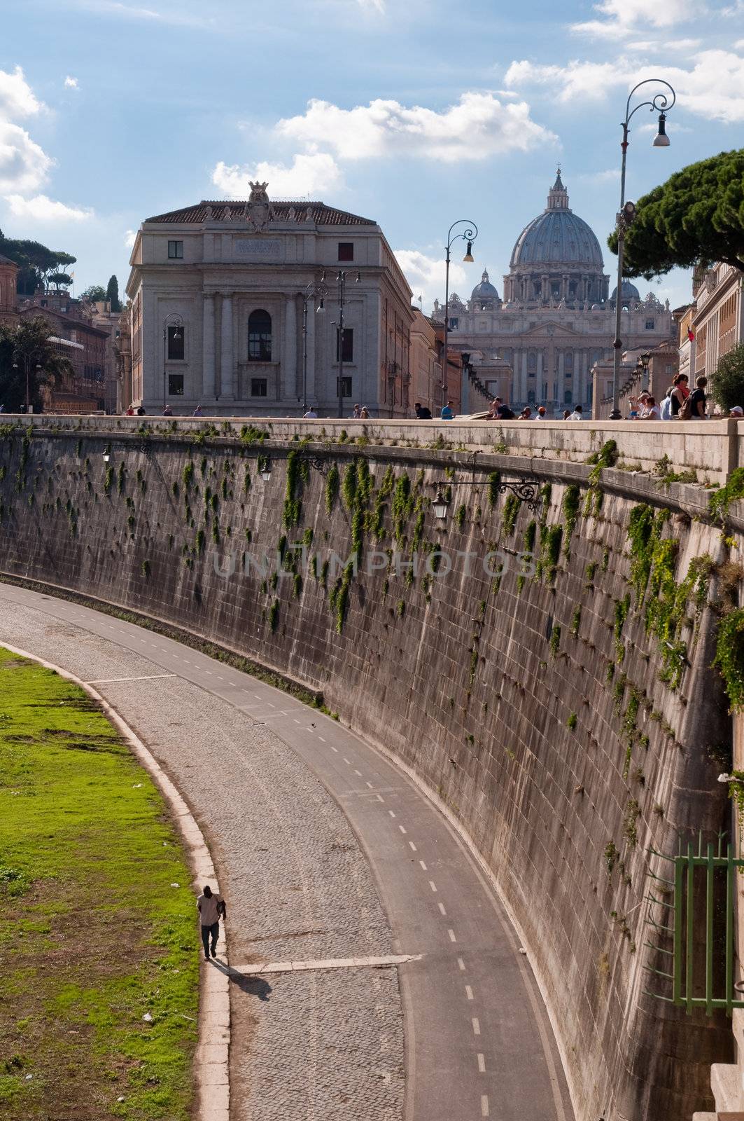 Man Walking on street beside Tevere river with Vaticano background at Roma - Italy