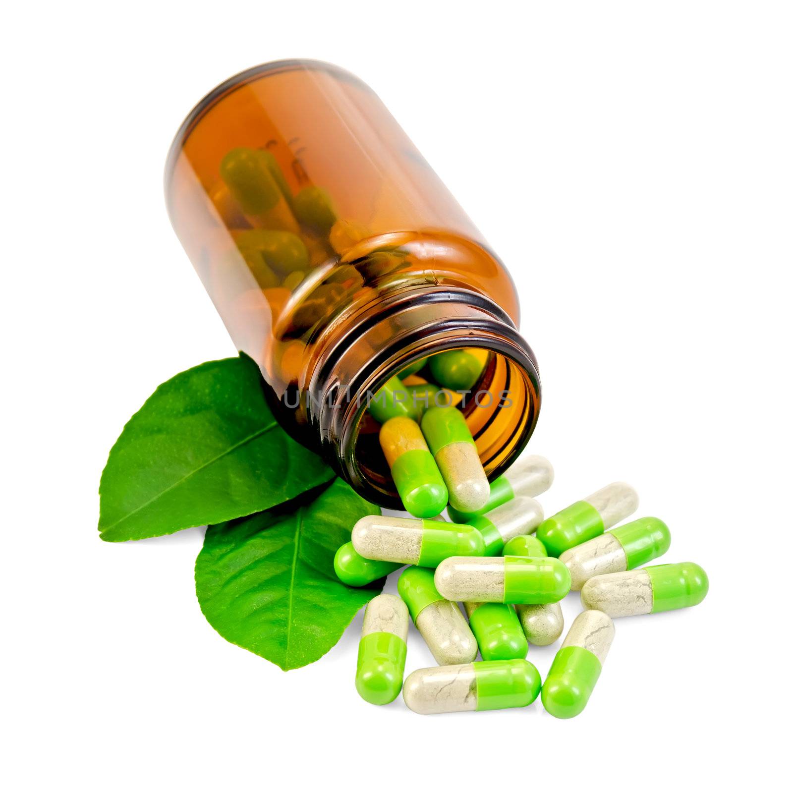 Green capsules in an open brown jar and on the table, two green leaf isolated on white background