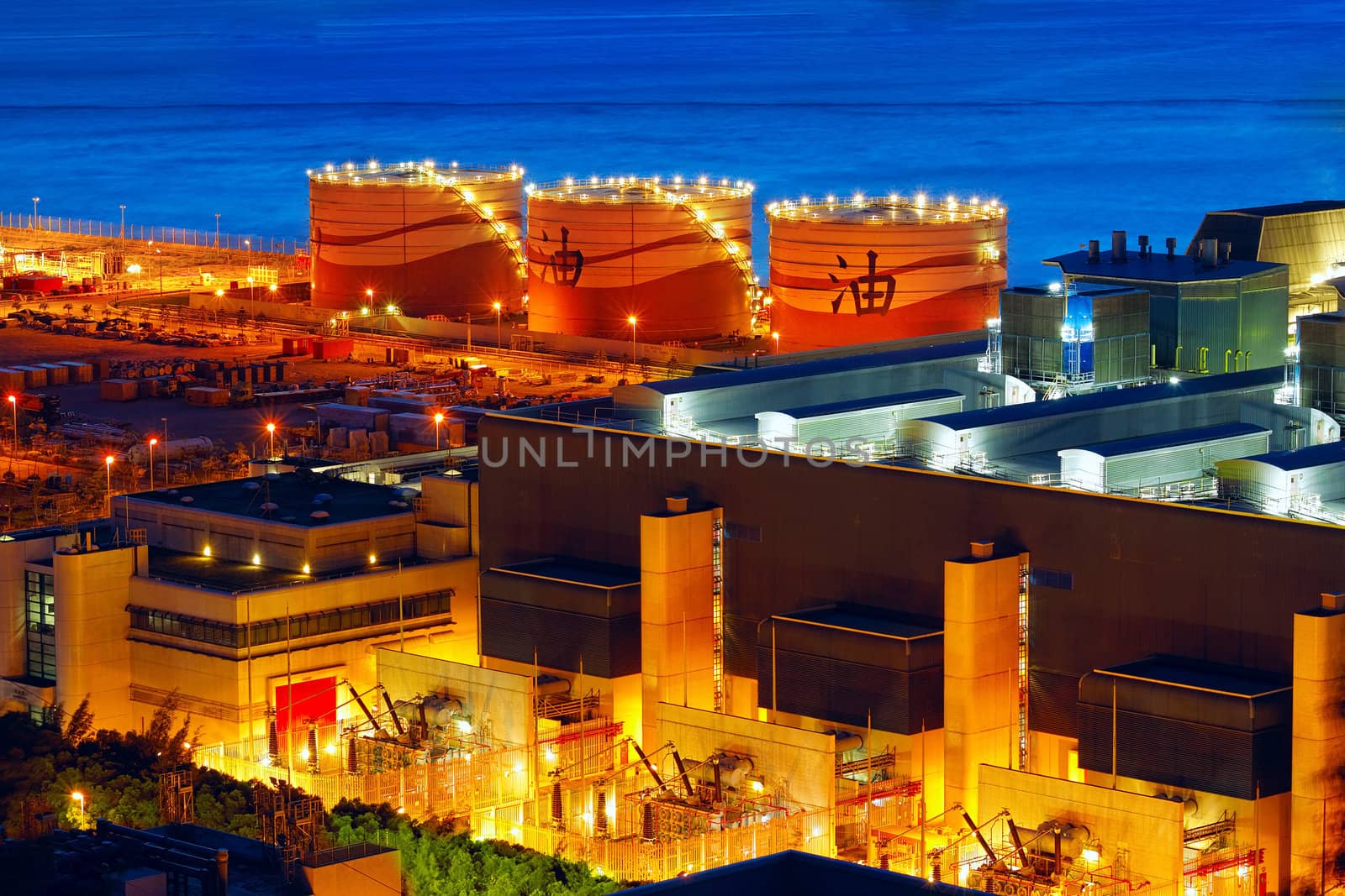 Oil and gas refinery at twilight - Petrochemical factory, chinsese oil word on tank
