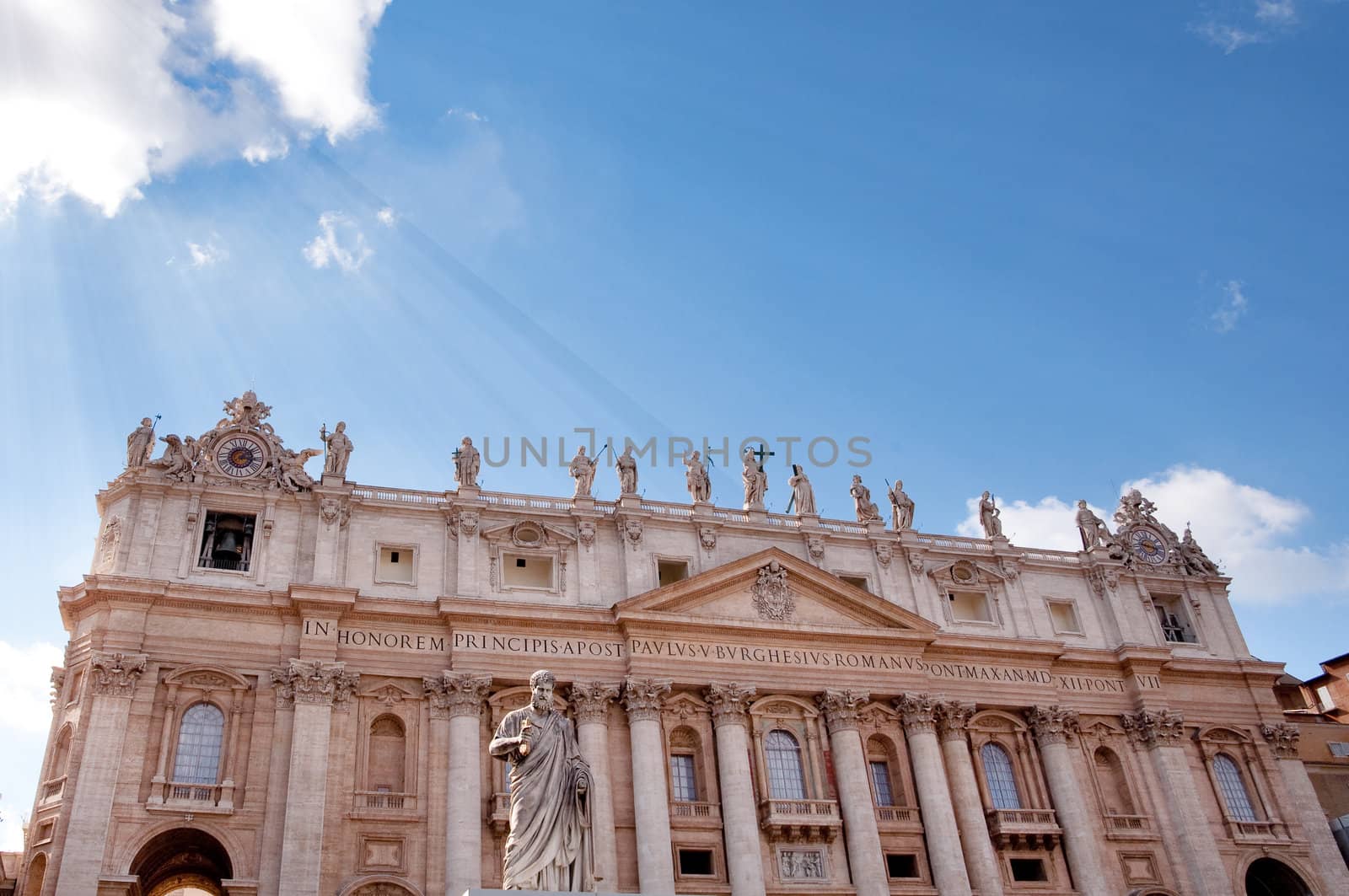 St Peters Basilica with sun rays on the blue sky at Roma Vatican City - Italy