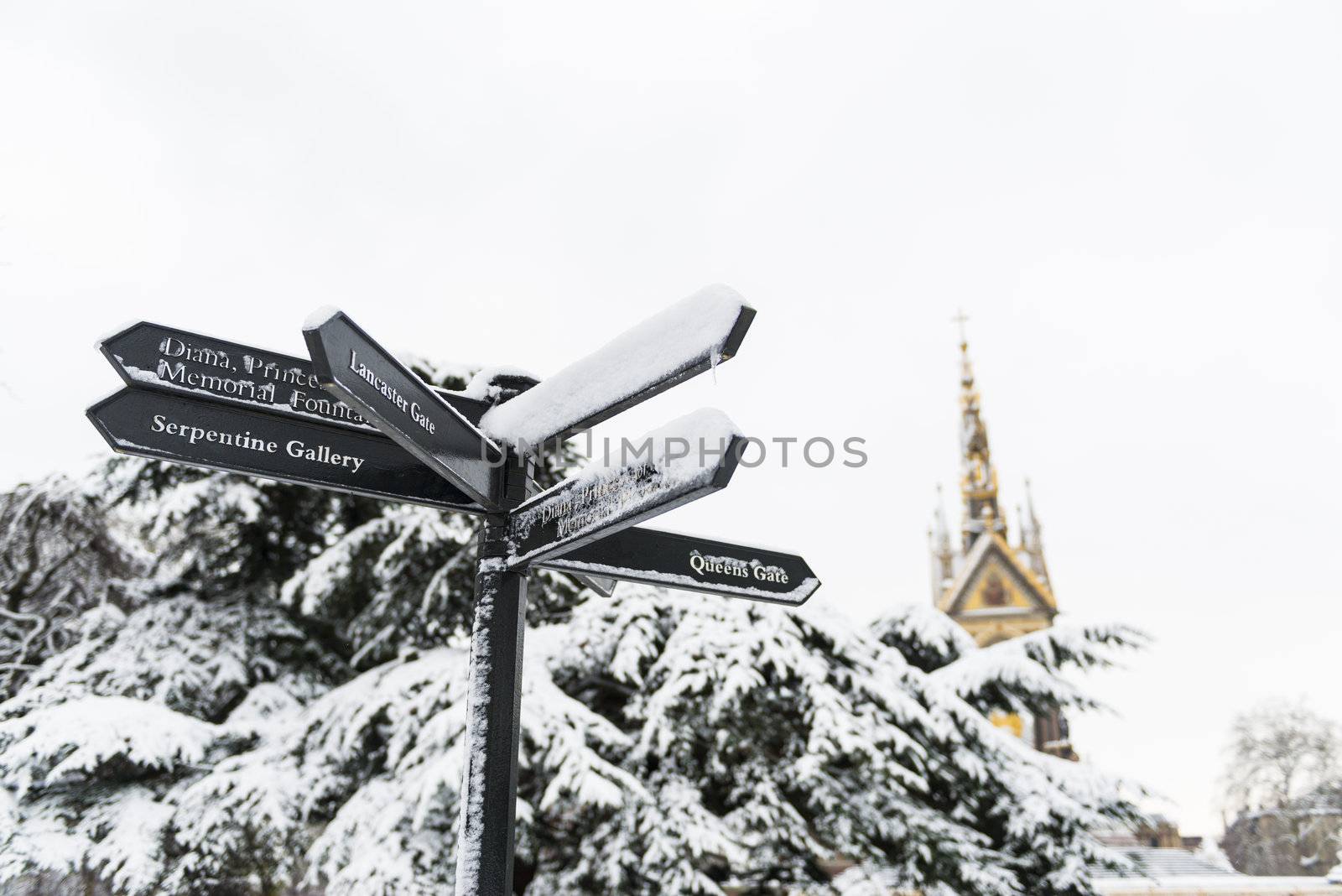 Directions sign in Hyde Park, with Albert Memorial in the background after three days of blizzards.