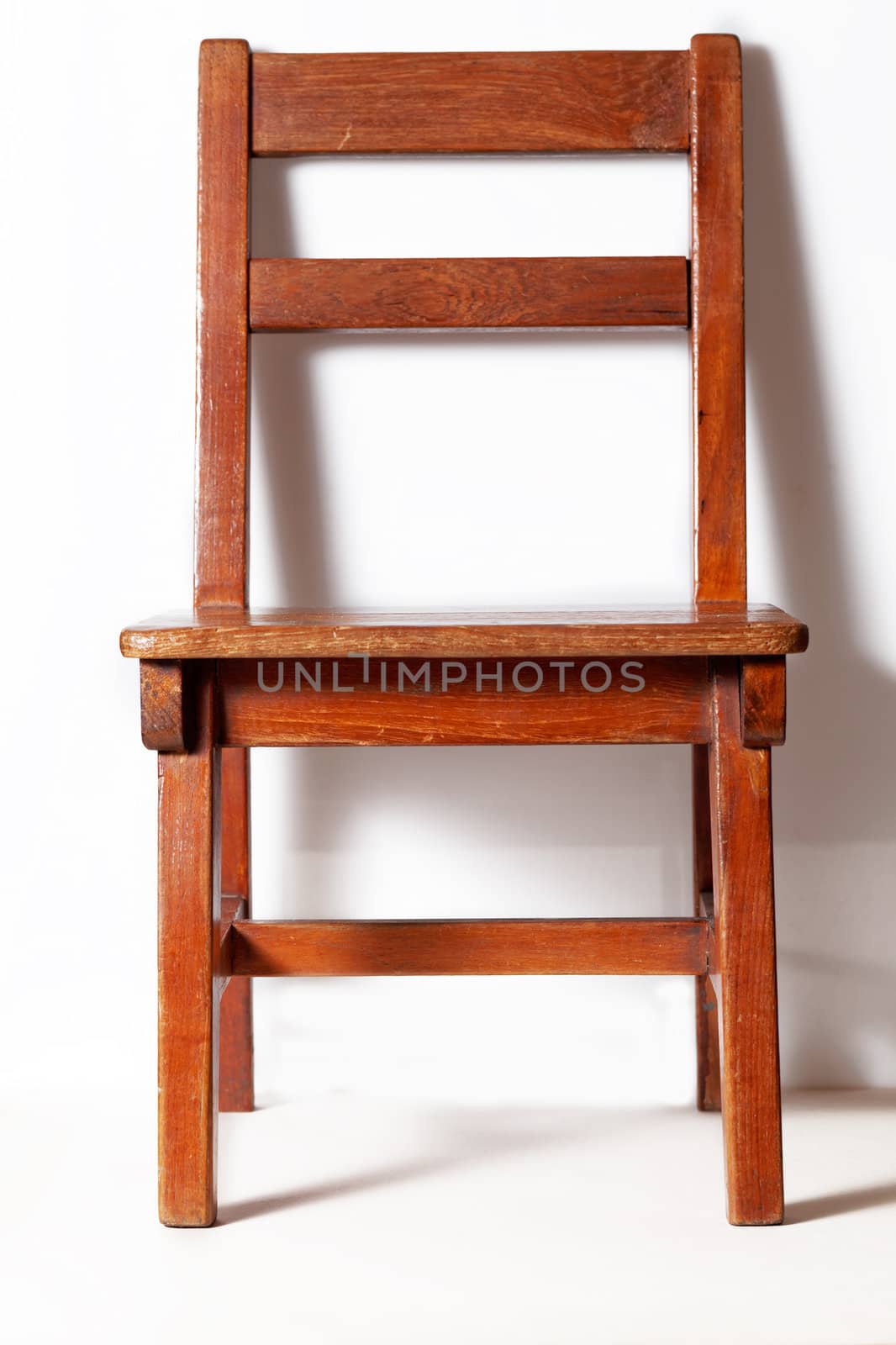 wood chair with white wall in background 