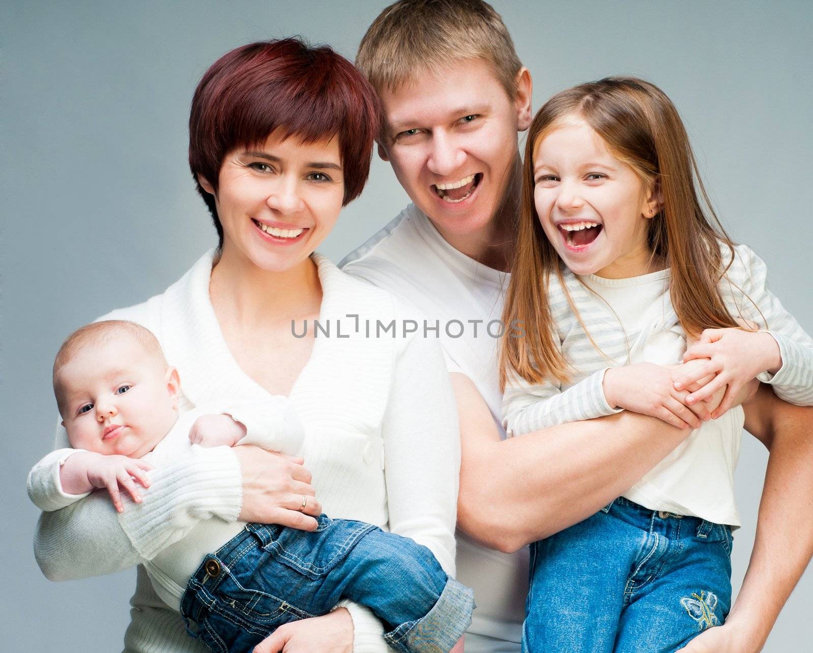 Pretty smiling family looking at the camera by GekaSkr
