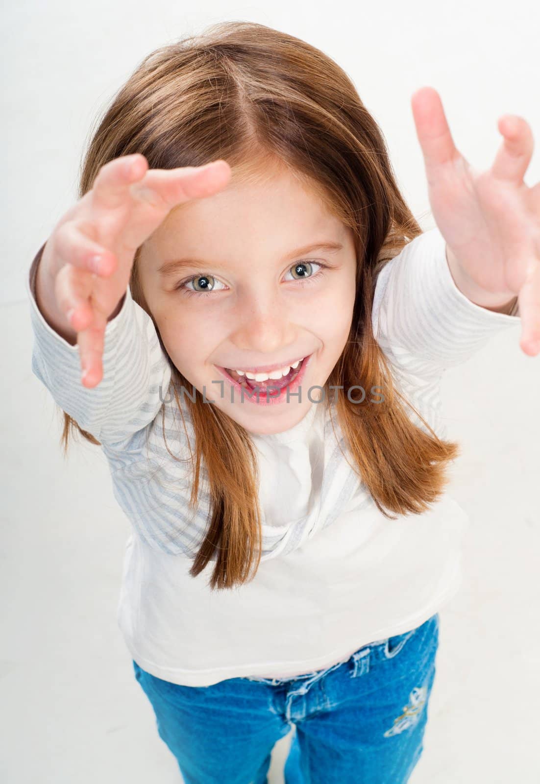Portrait of a lovely little girl with hands up