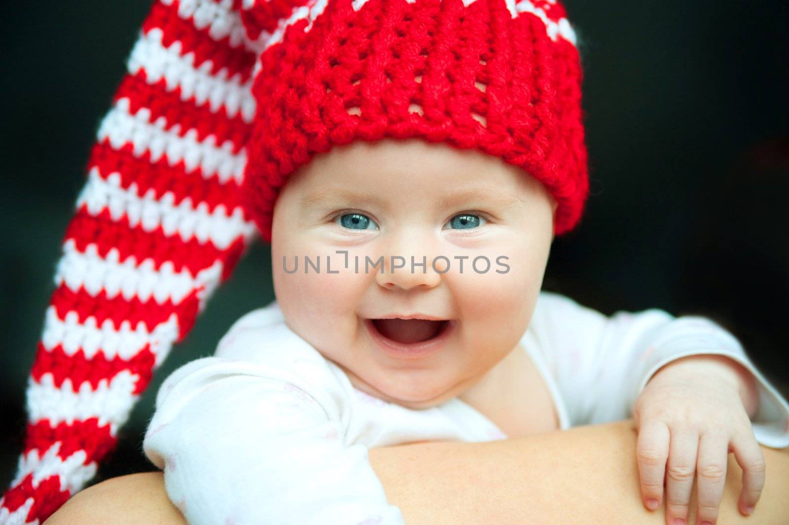 smiling pretty baby in red hat