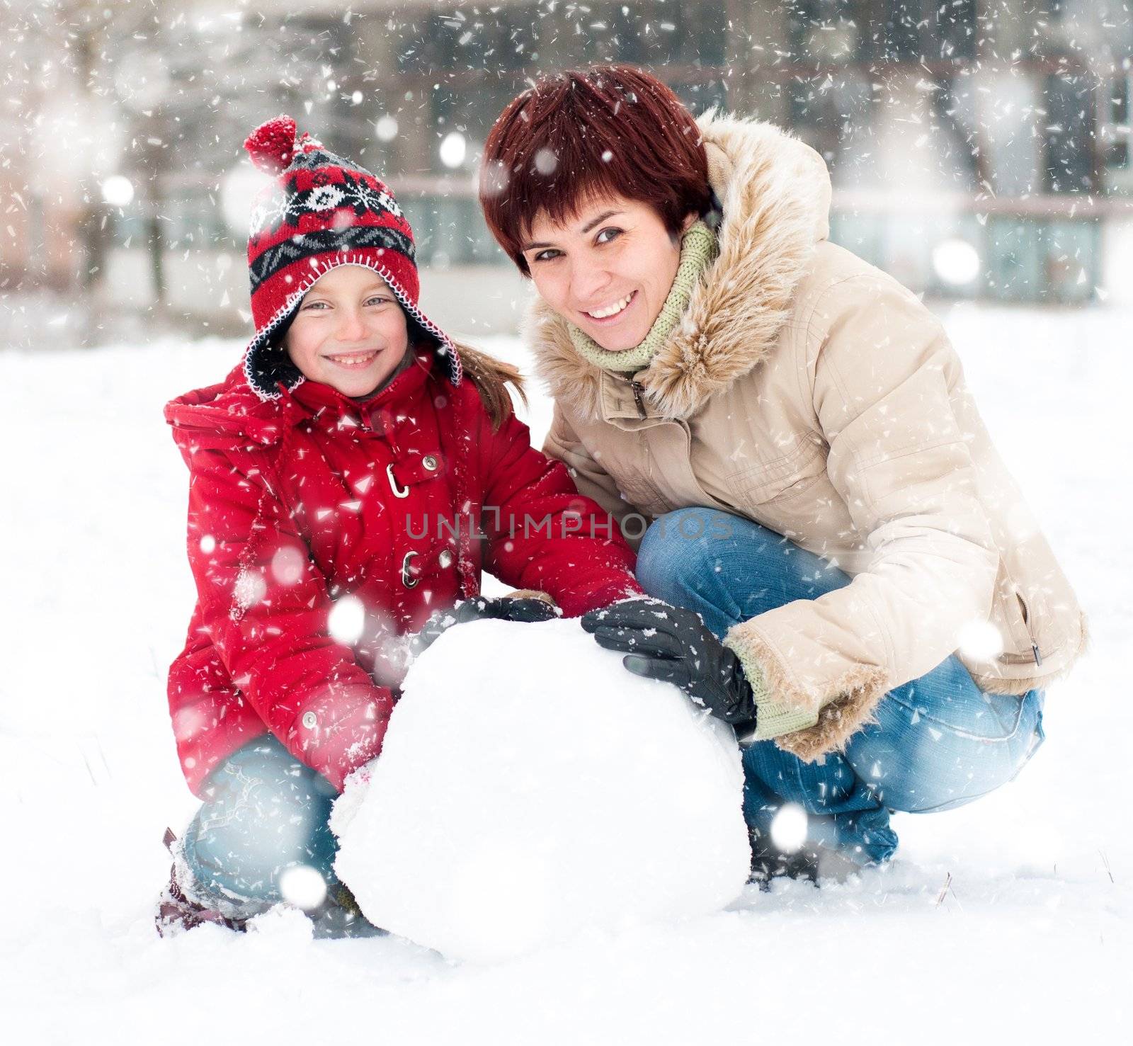 Happy family with snowman winter portrait