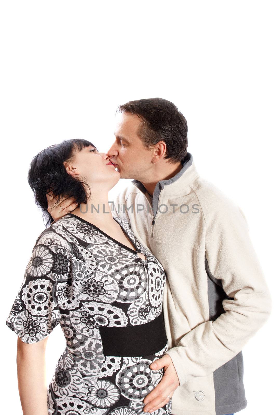 man kissing pregnant woman on white background
