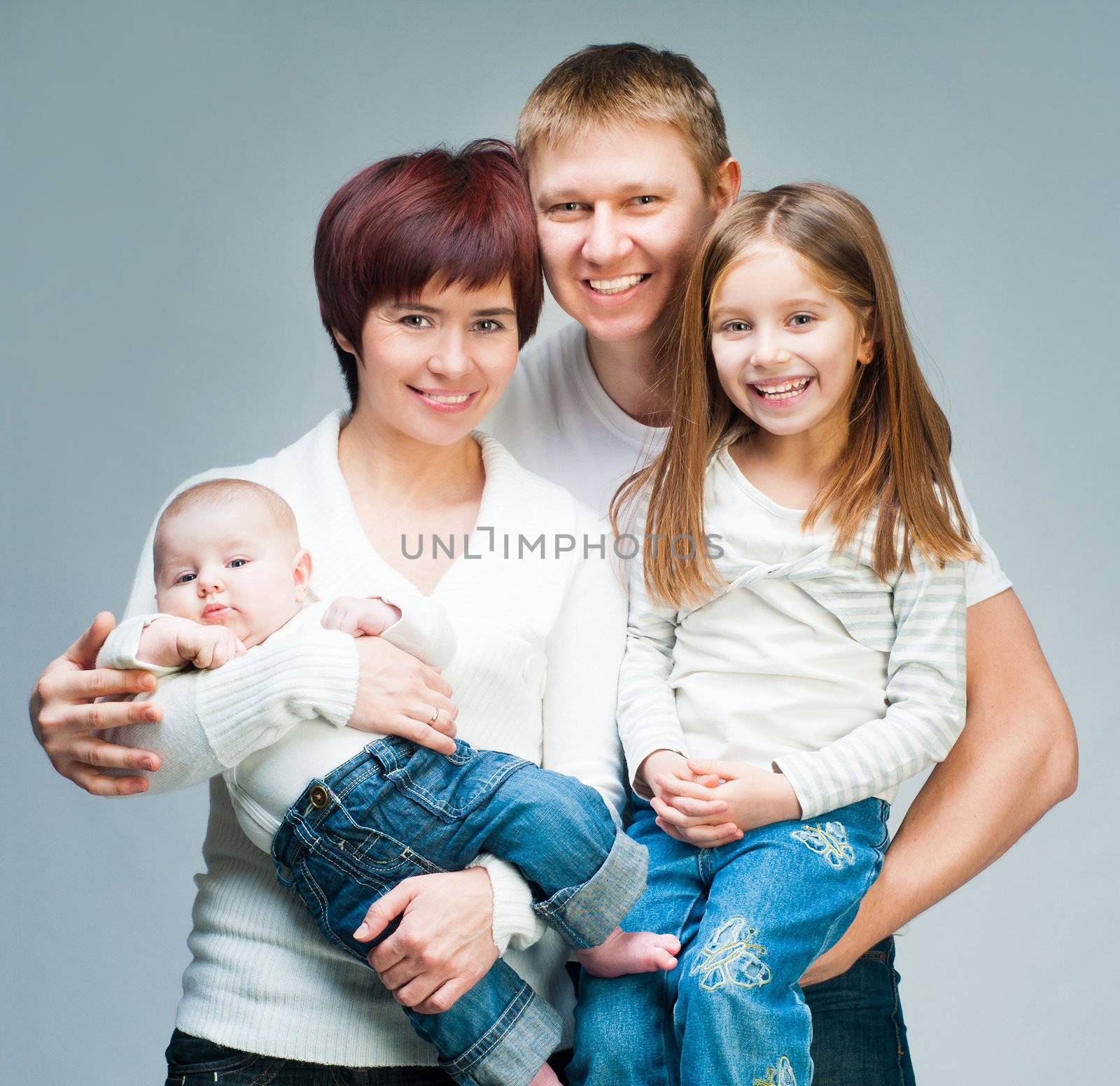 Nice smiling family looking at the camera by GekaSkr