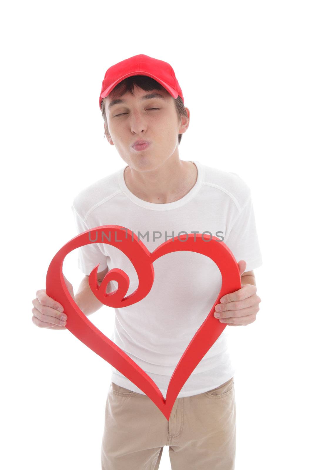 Teen boy with red love heart kissing, puckering up.  White background.