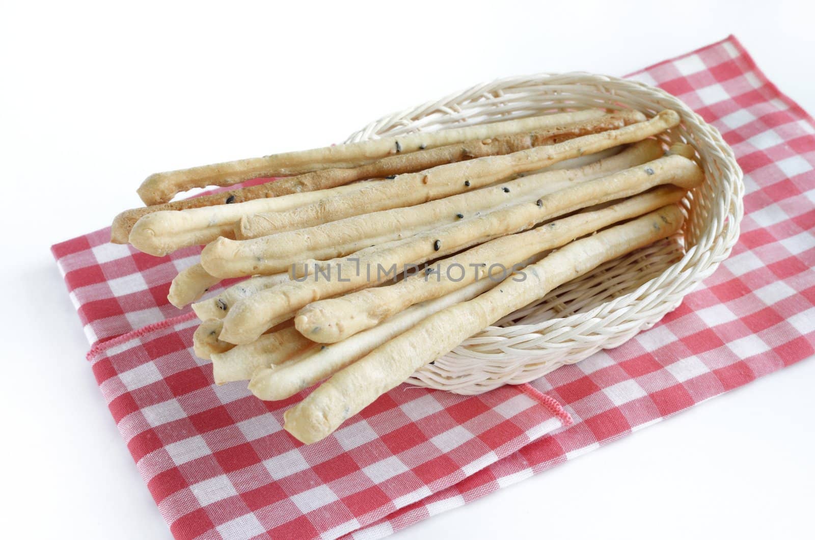 bread sticks with basket isolated on white