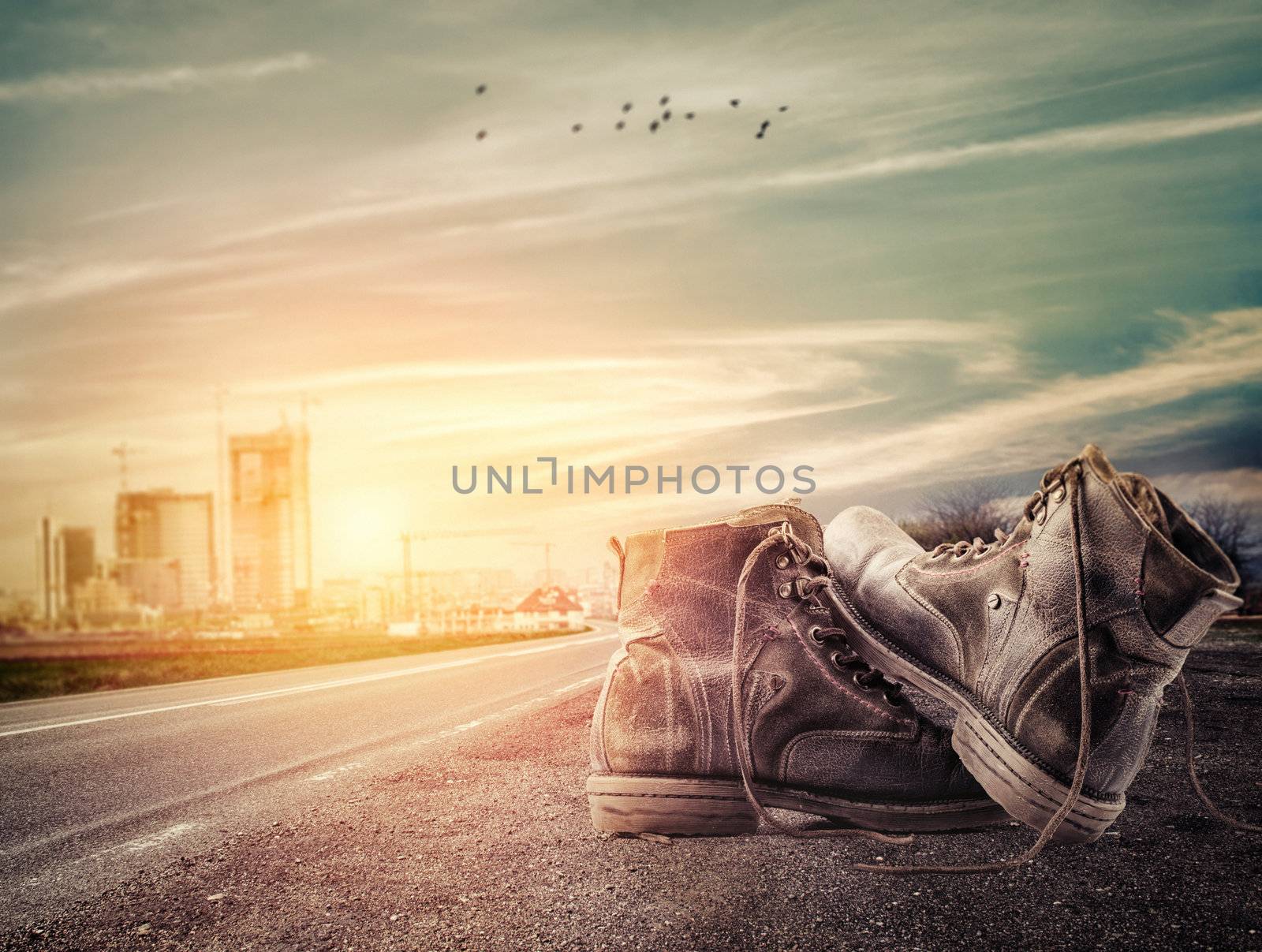 Pair of boots sit on the edge of the road