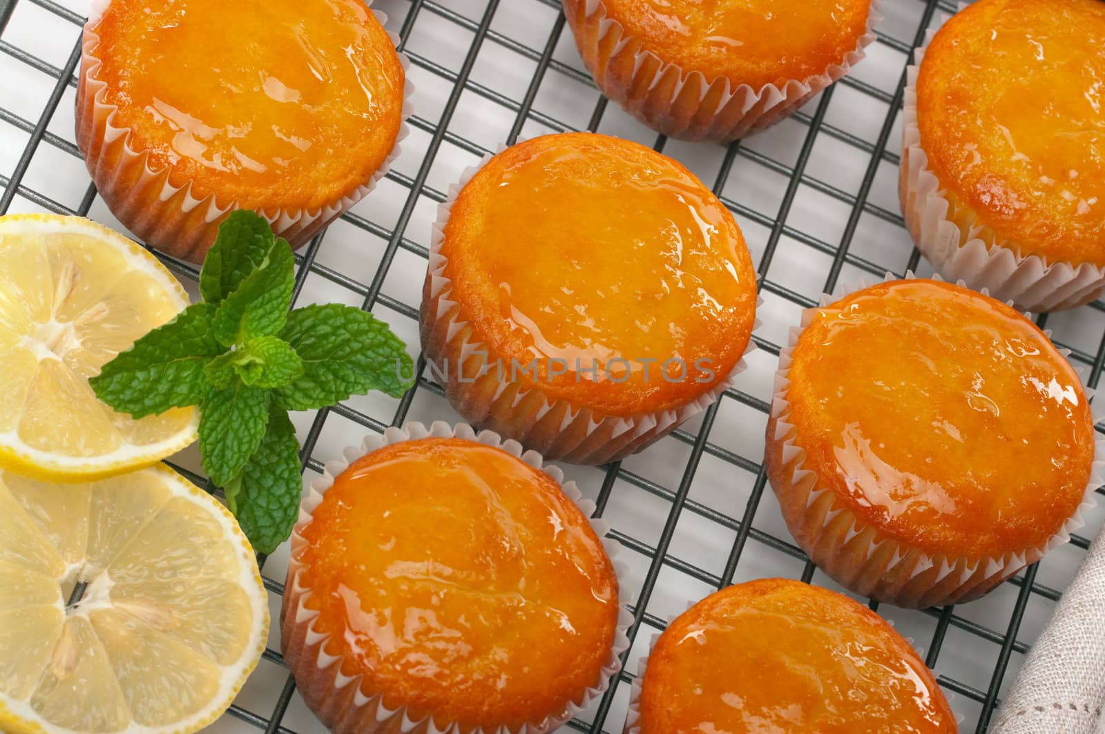Citrus cupcakes with lemon glaze on cooling rack