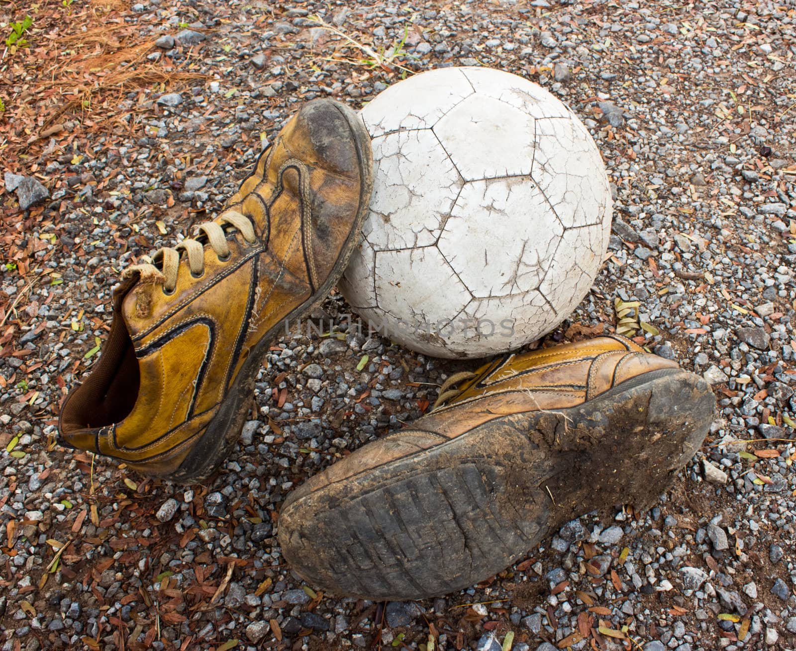 a old ball and old shoes on the ground