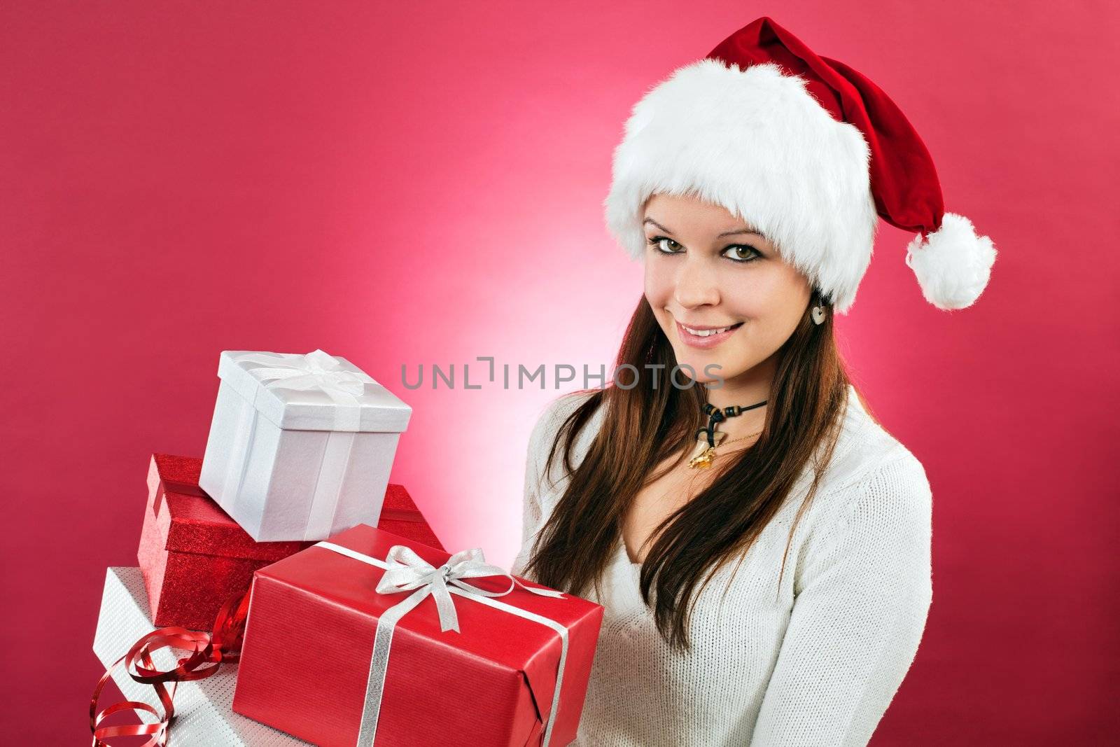 Happy girl holding christmas gifts by sumners