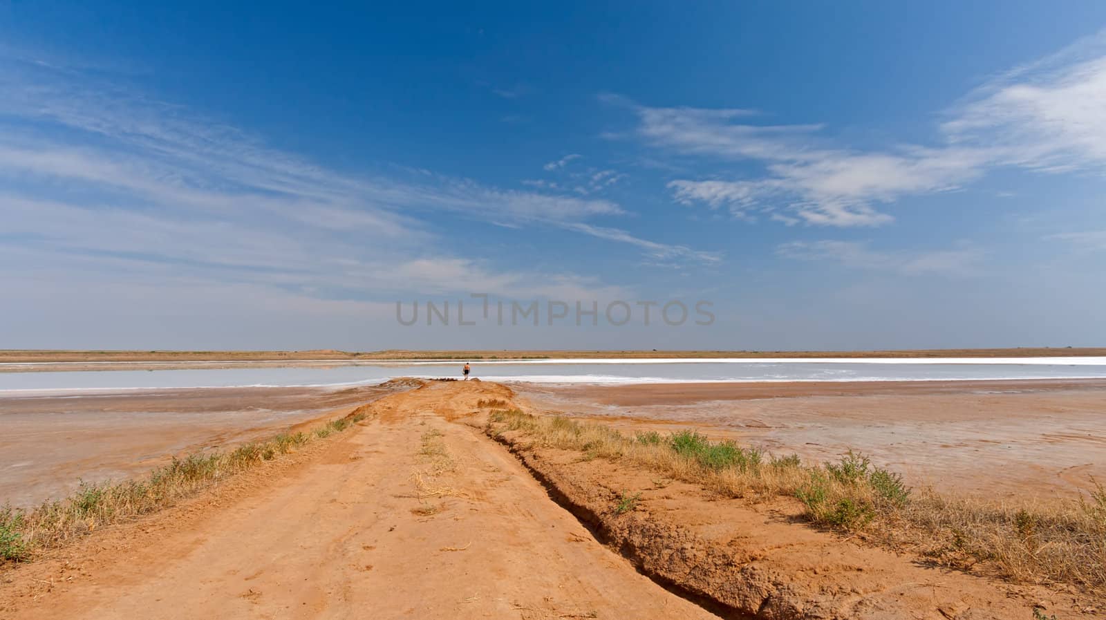 Views of  desert landscape and  salty lake on  background of blue sky, Russia.