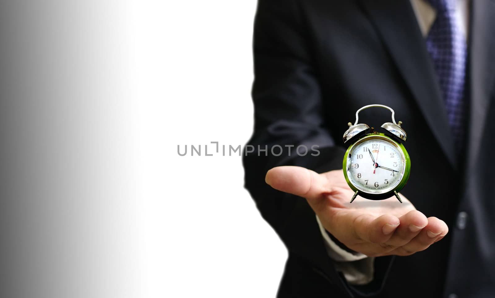 Alarm clock on businessman's hand, Time over concept