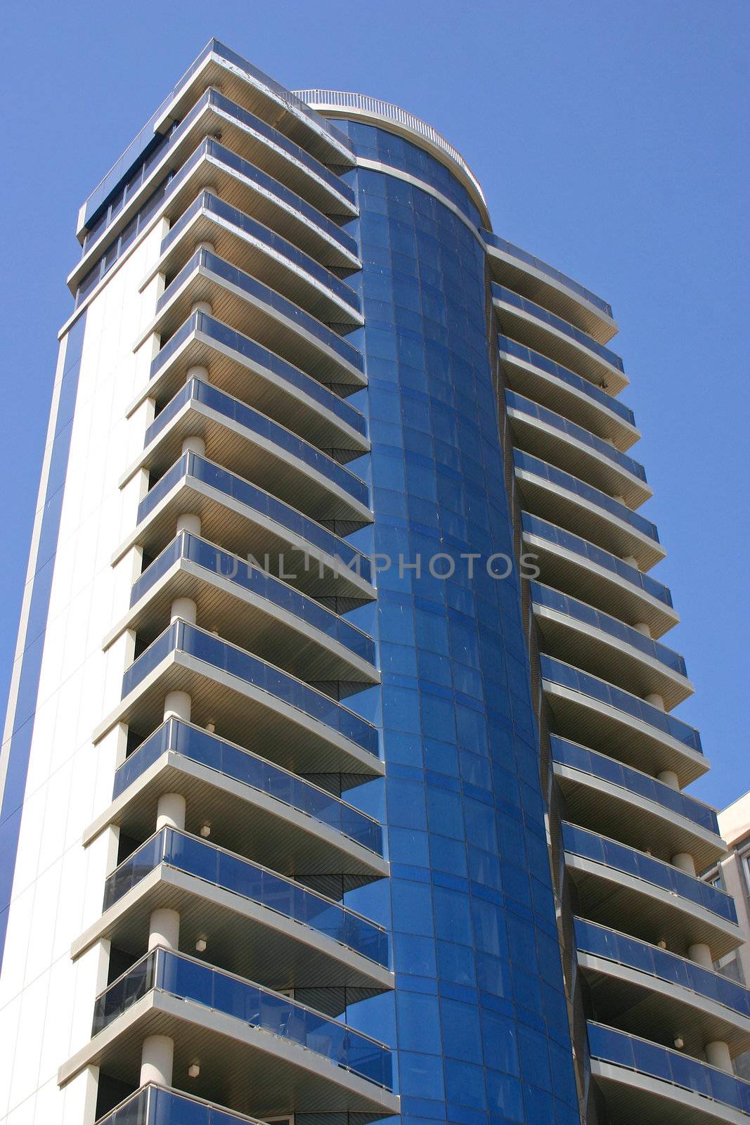 Blue skyscraper with a lot of glass at the coast