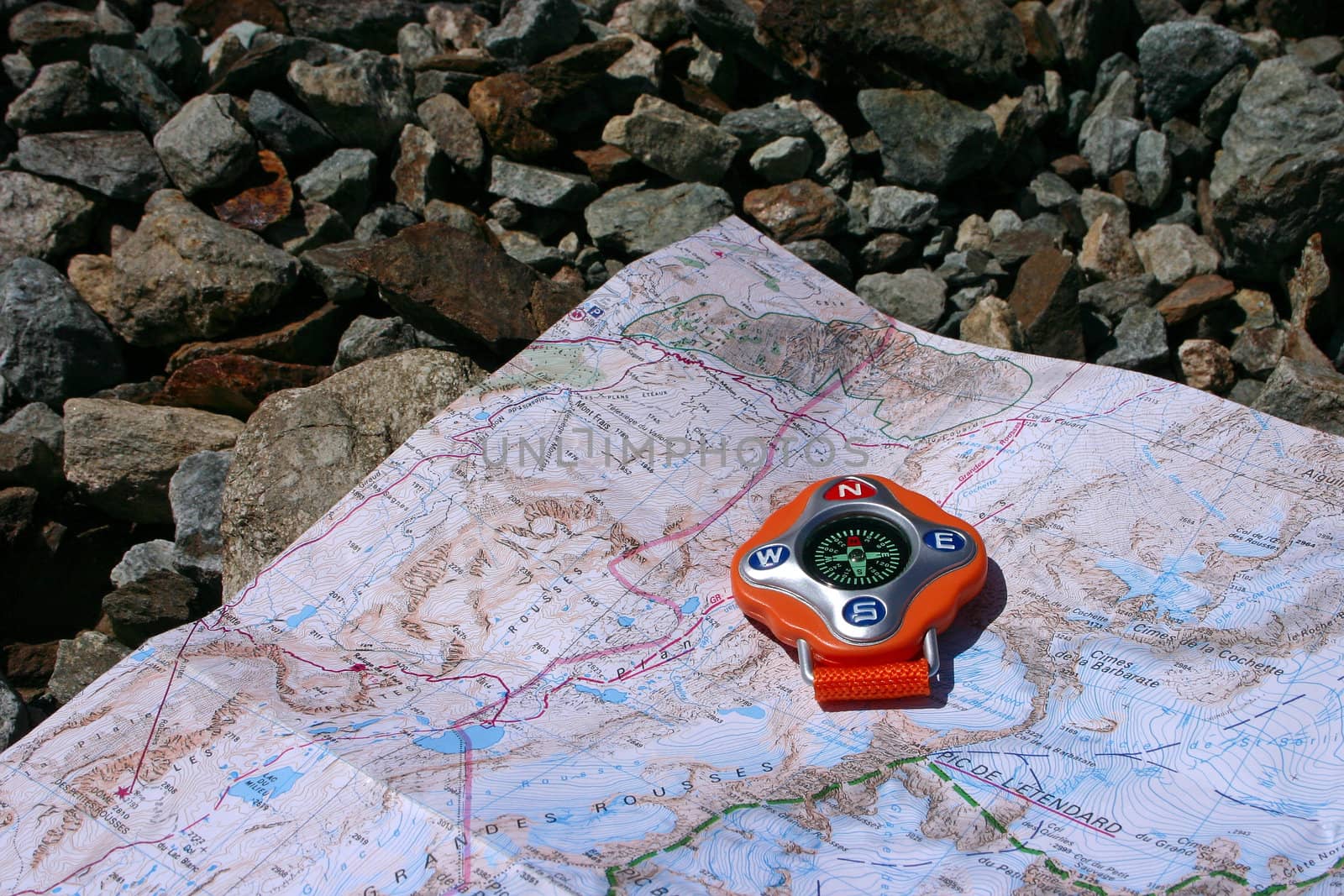 Orange compass to show the way in the mountains
