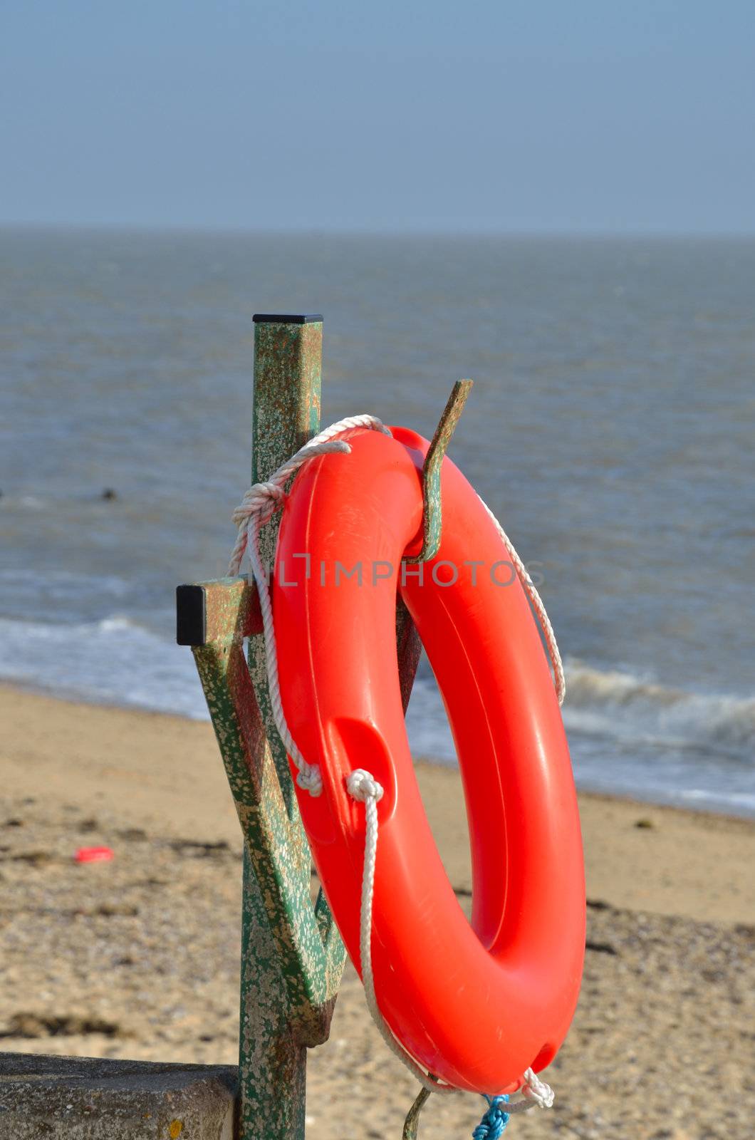 Orange lifebelt by sea
