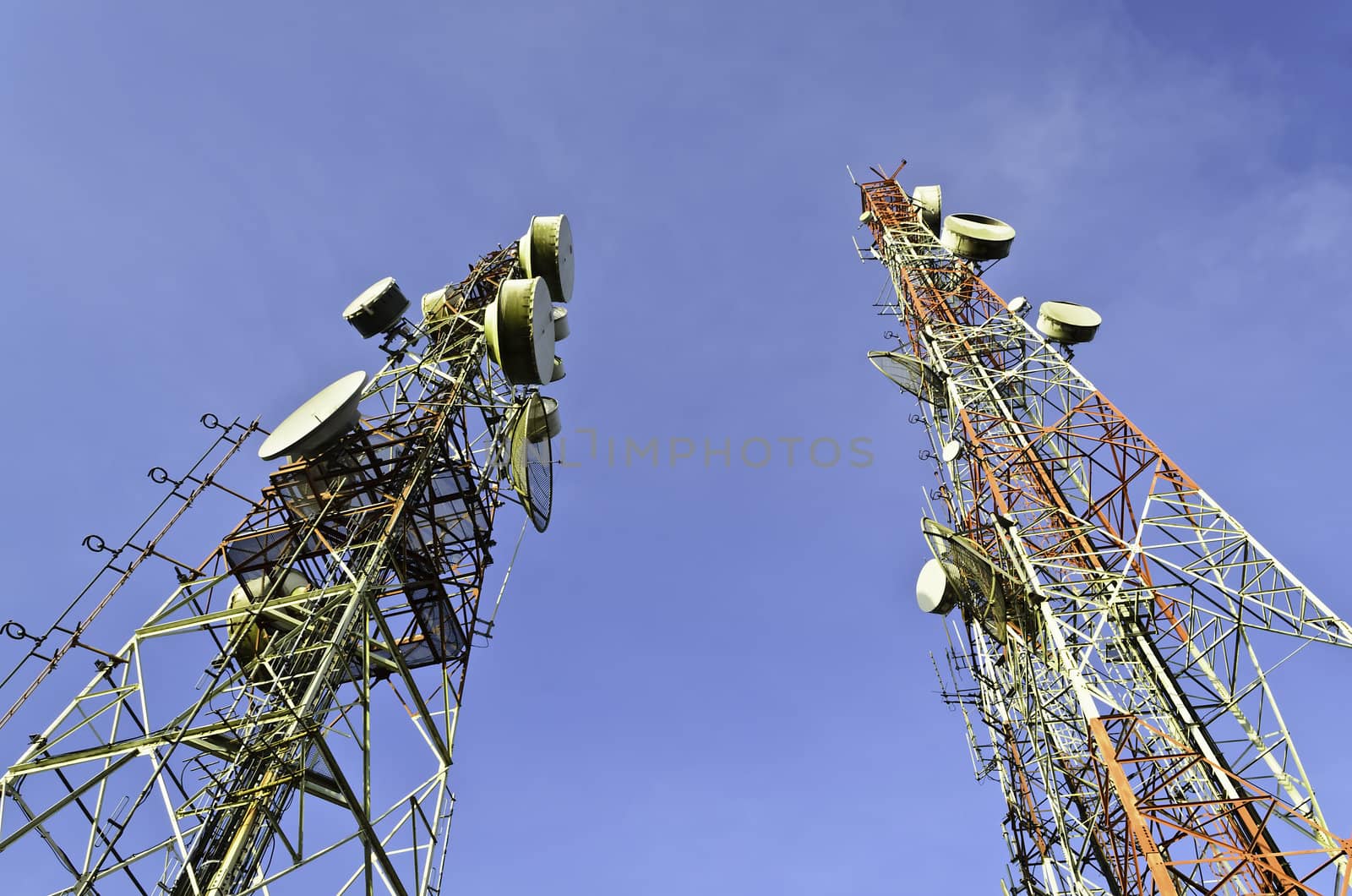 Telecommunication towers with blue sky by bentaboe