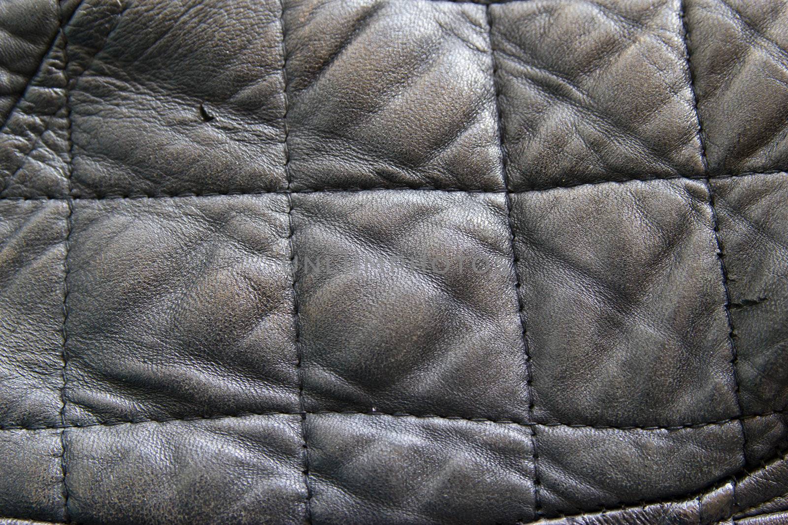 leather texture colose-up with linear stiches. Part of a leather jacket.