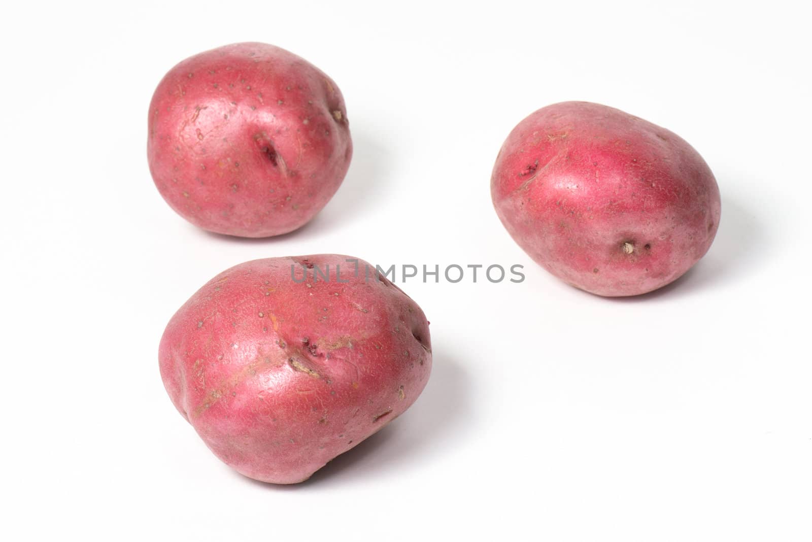 Three Red Potatoes on White
