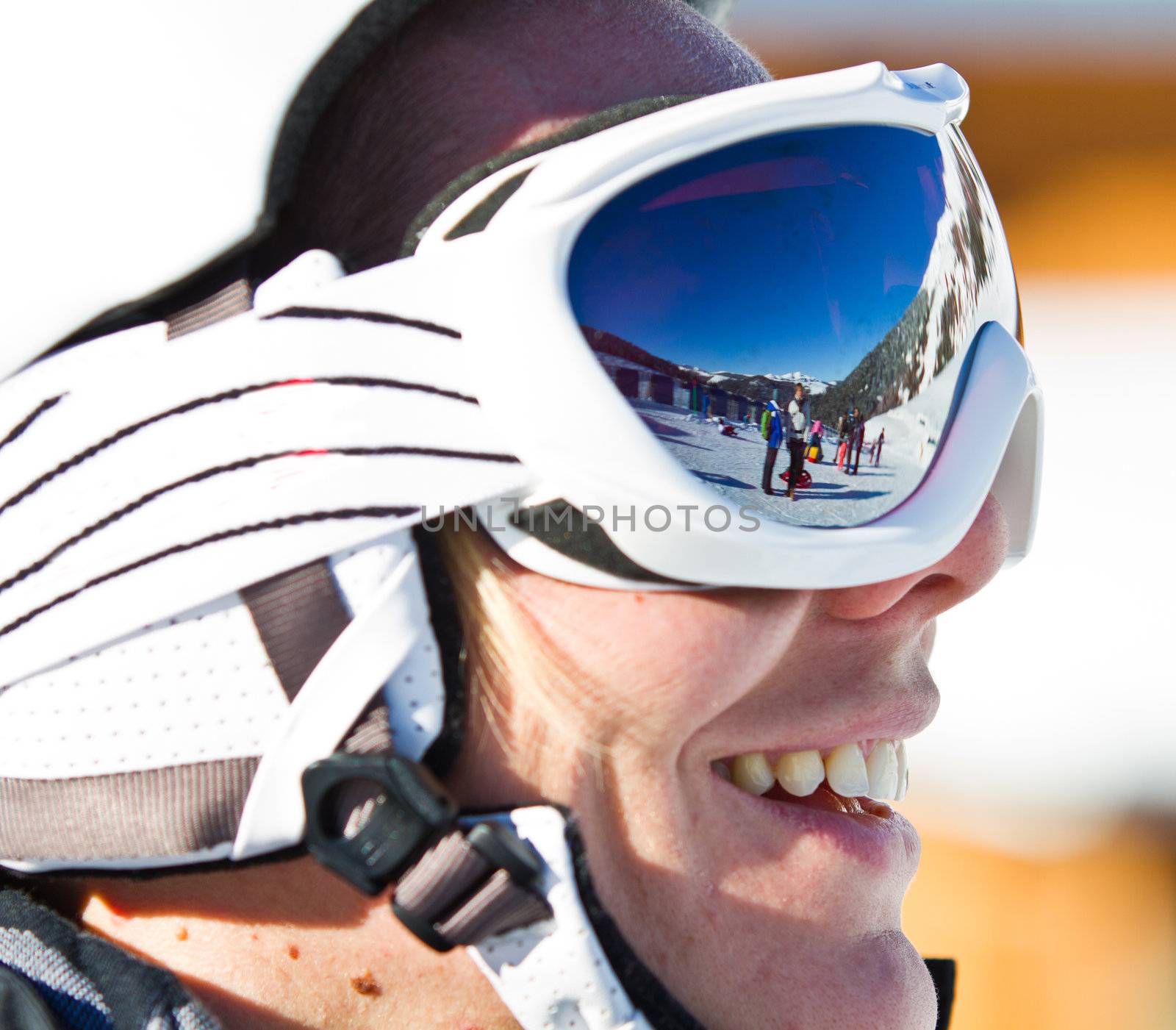 Portrait of a smiling skier woman with helmet
