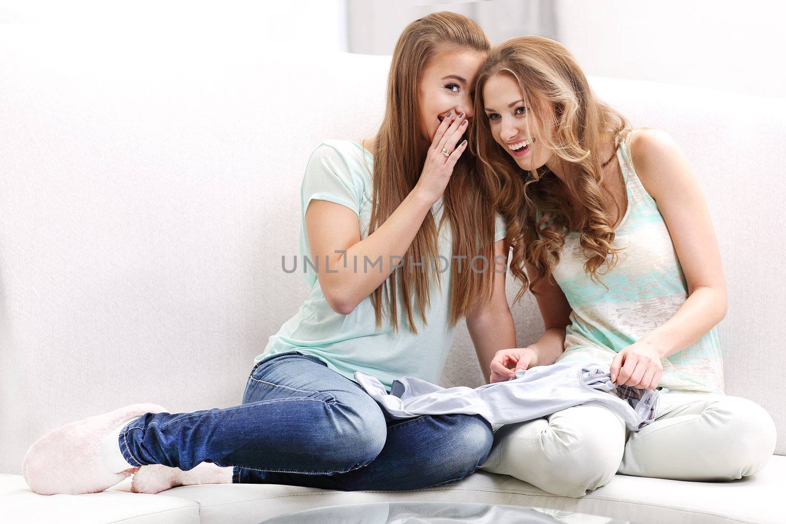 Two young women whispering