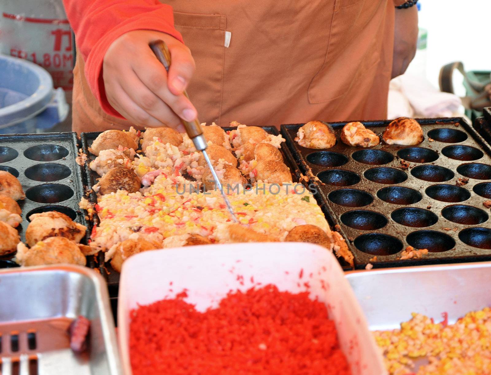 Japanese takoyaki balls at a food market  by siraanamwong