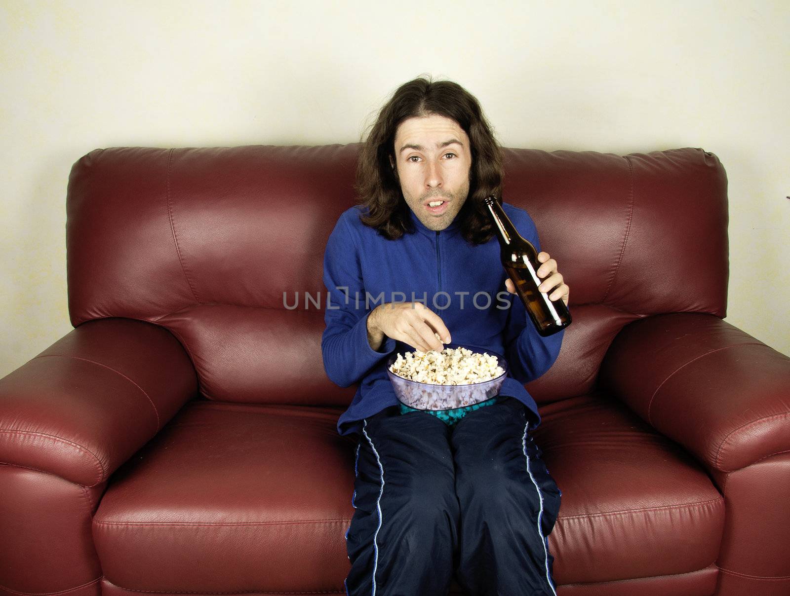 a young man look the football on the couch