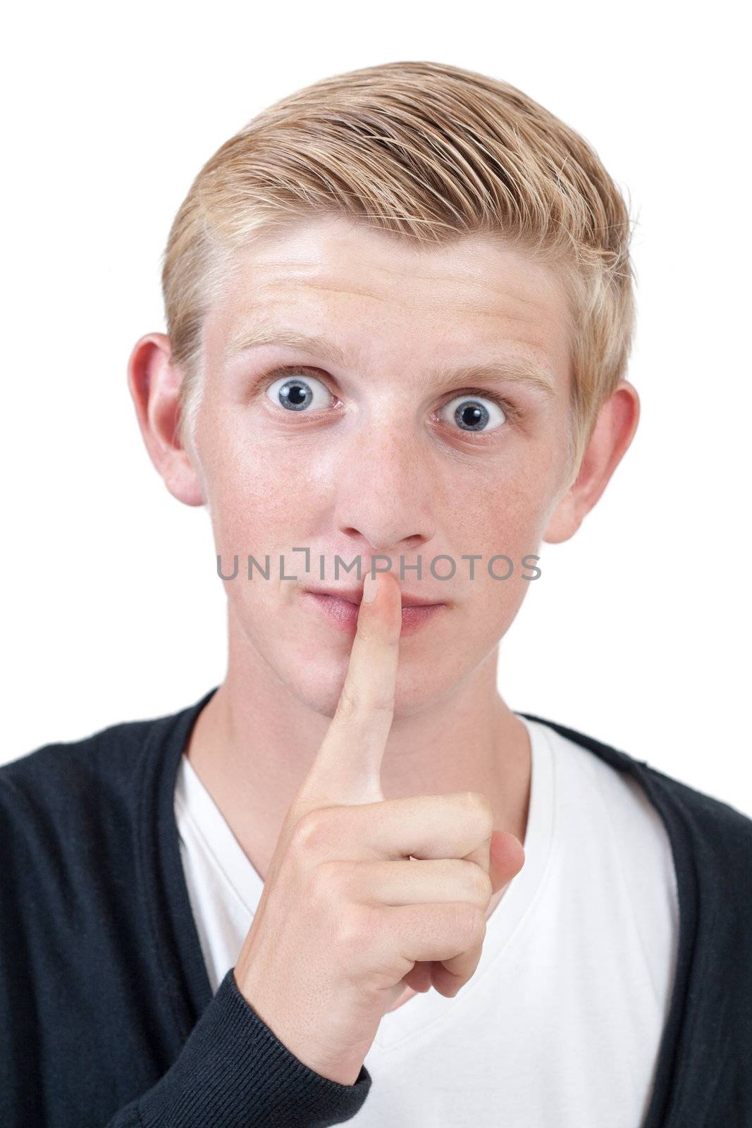 young blond man showing silence gesture, finger over mouth - on white background