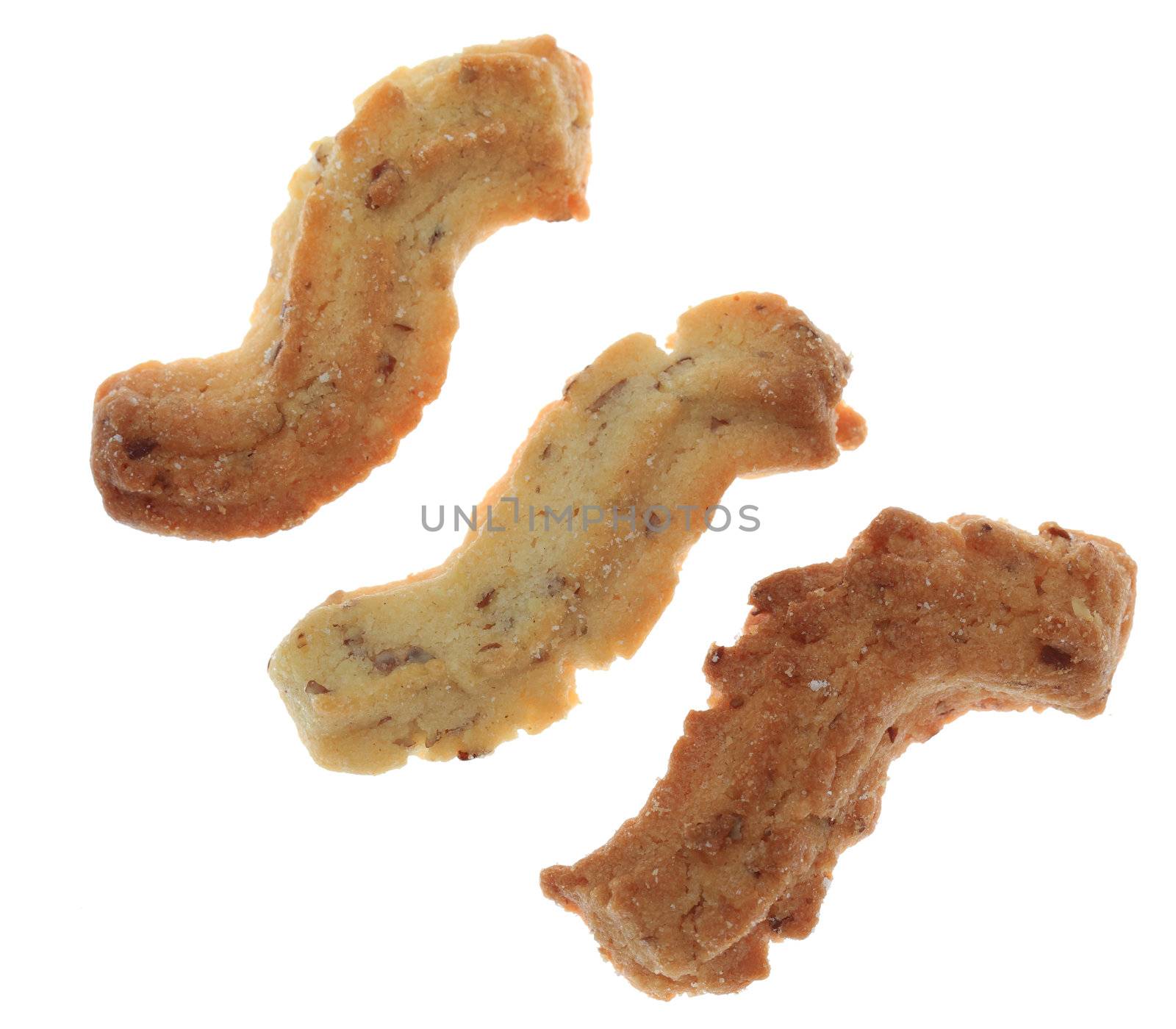 Three spritz cookies isolated against a white background.