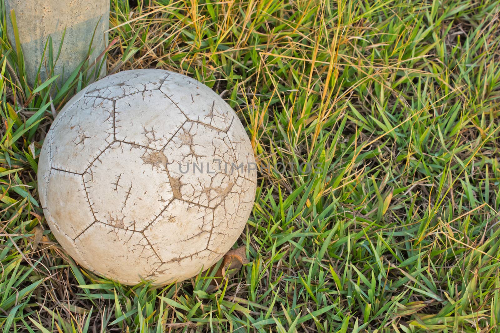 Old Soccer Ball. Poor school soccer field.