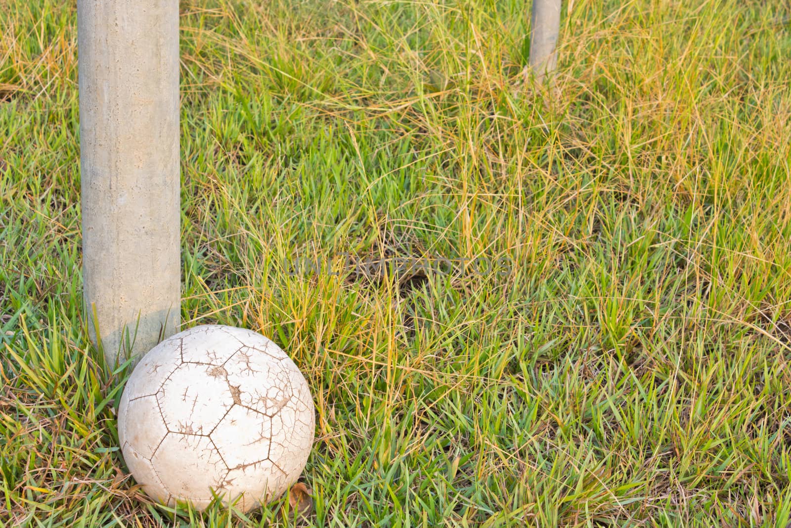 Old Soccer Ball. Poor school soccer field.