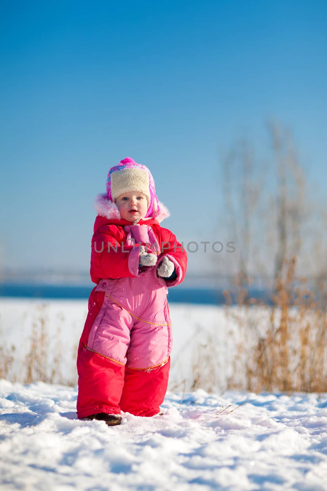 child with snow in winter by vsurkov