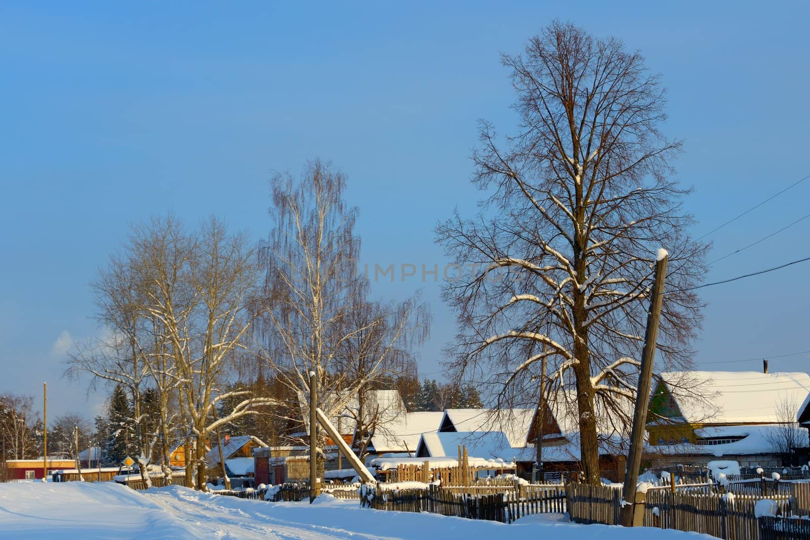 snow-covered village with a triangular roof on the road