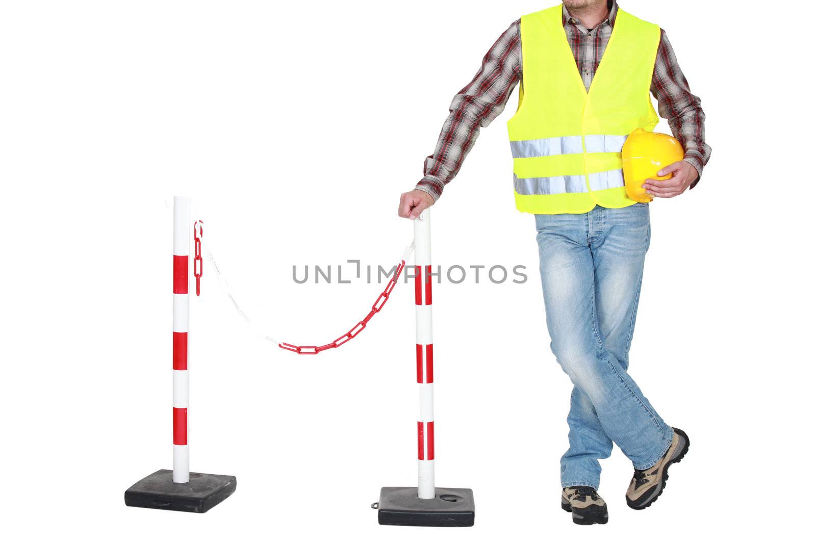 Traffic guard standing beside a barrier by phovoir