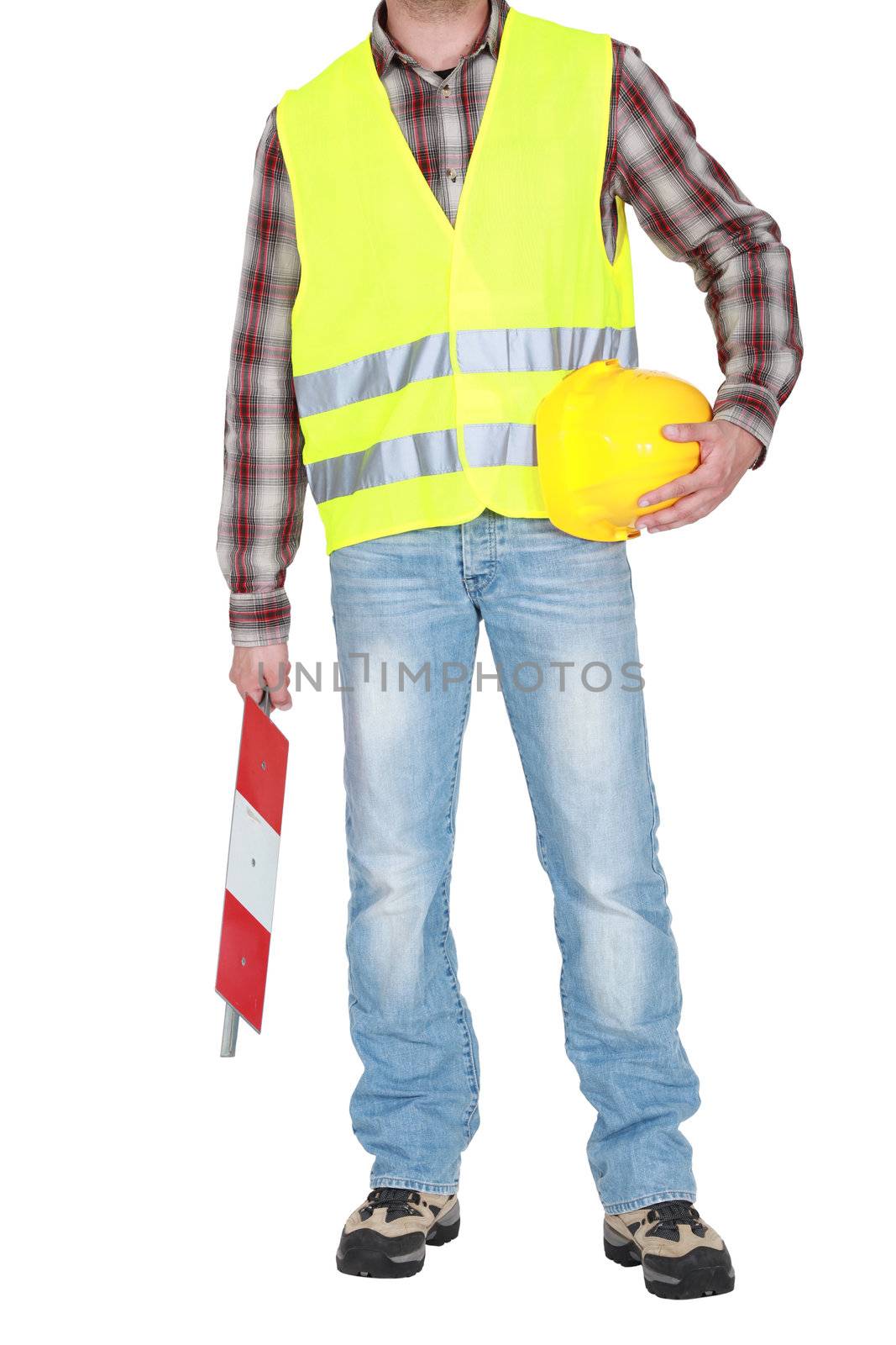 builder standing hard hat in hand wearing safety jacket