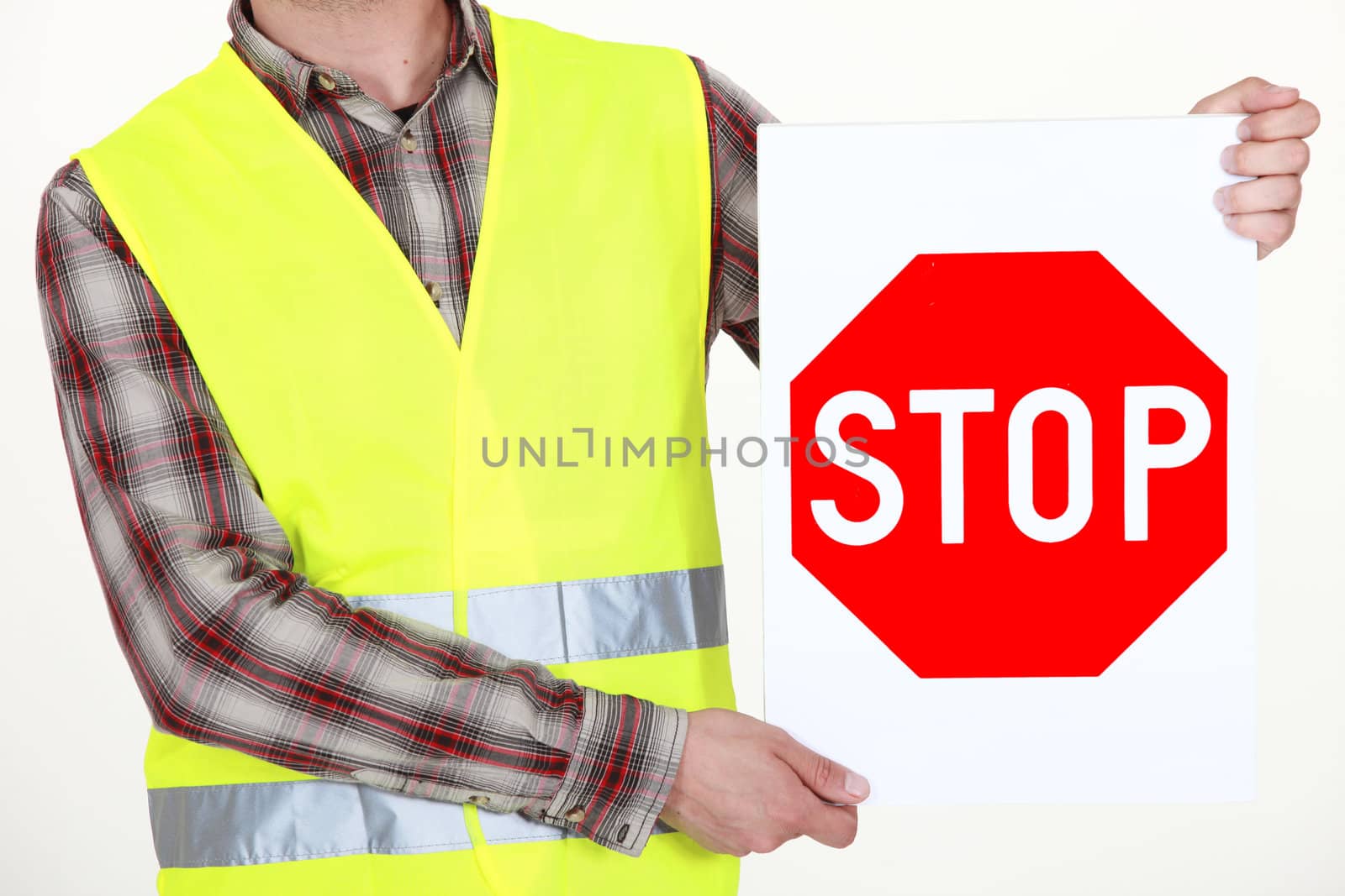 Highway worker with stop sign by phovoir