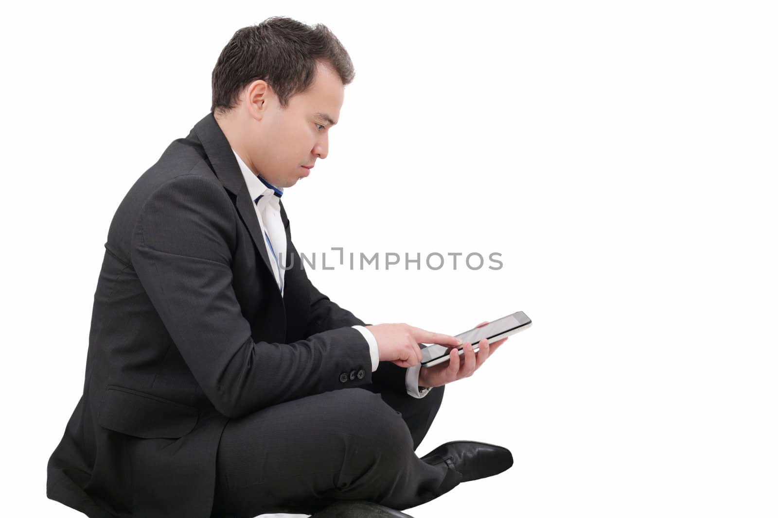 Young man sitting on a floor and using tablet pc