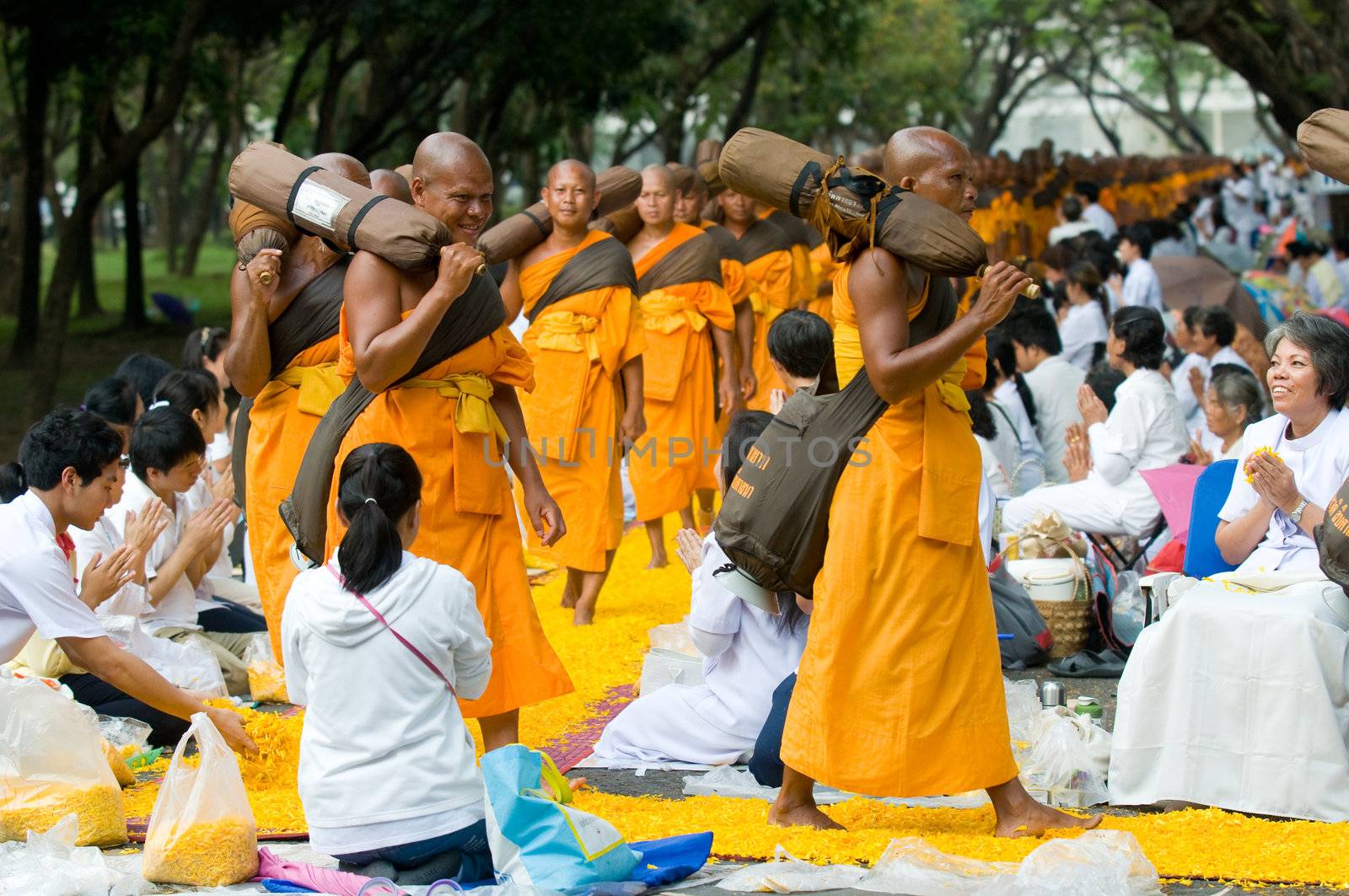 PATHUM THANI - JANUARY 27: 1,128 Buddhist monks wandering 460km through Bangkok and surroundings on yellow petals on January 27, 2013 in Pathum Thani, Thailand.