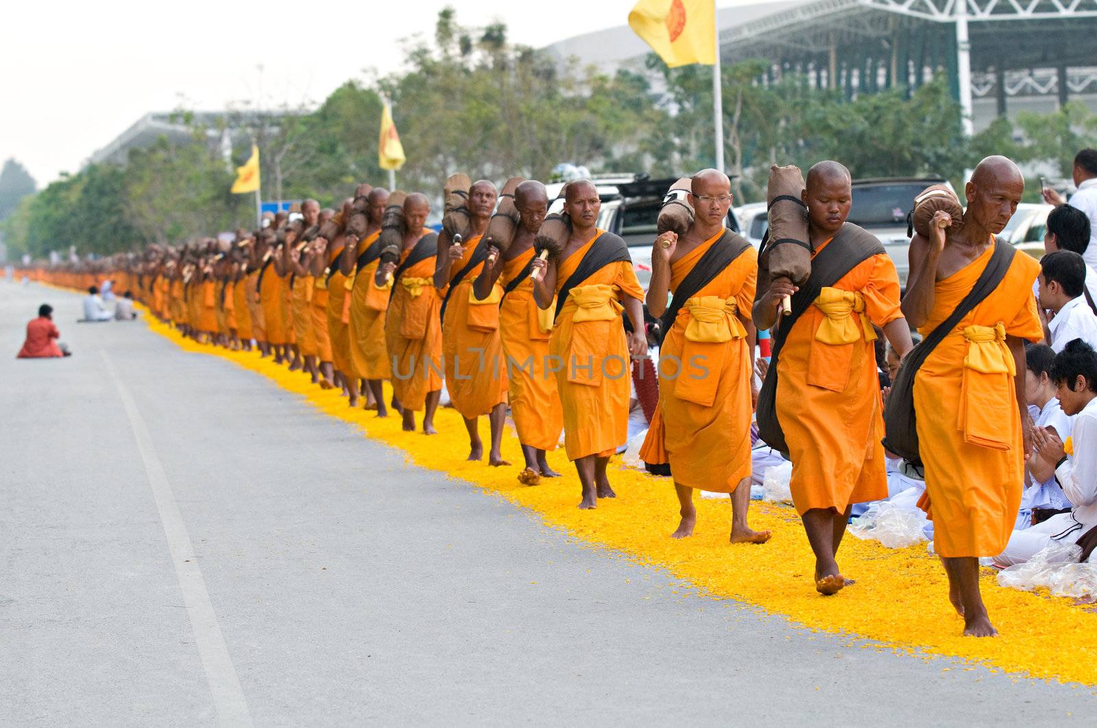 PATHUM THANI - JANUARY 27: 1,128 Buddhist monks wandering 460km through Bangkok and surroundings on yellow petals on January 27, 2013 in Pathum Thani, Thailand.