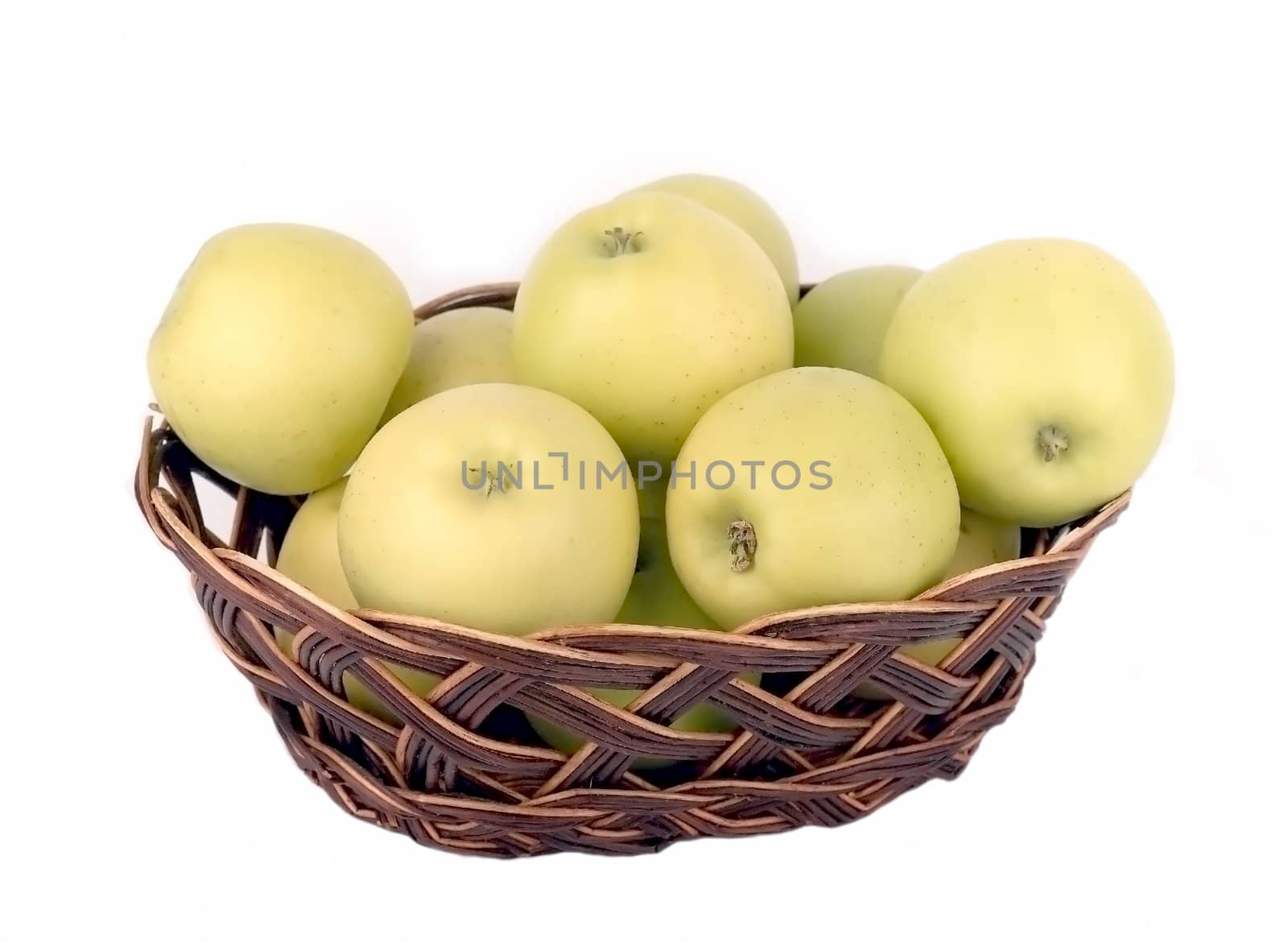 Green apples in a wicker vase on a white background