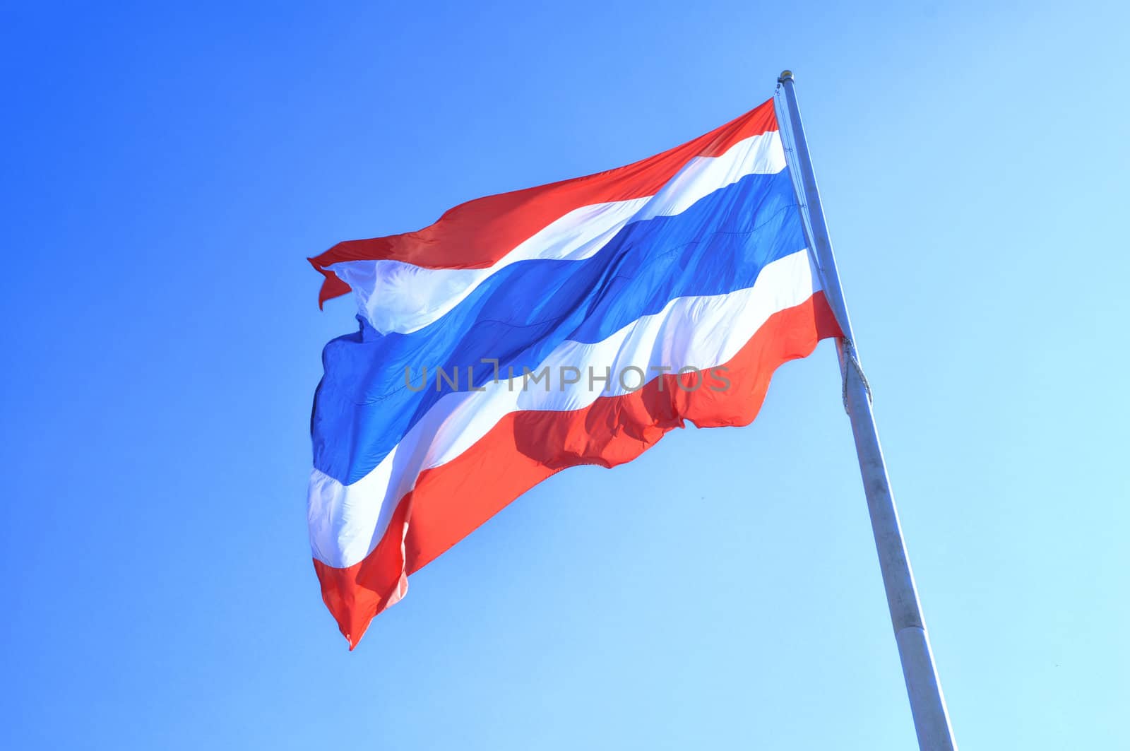 Thailand flag was blowing in the top of the pole.