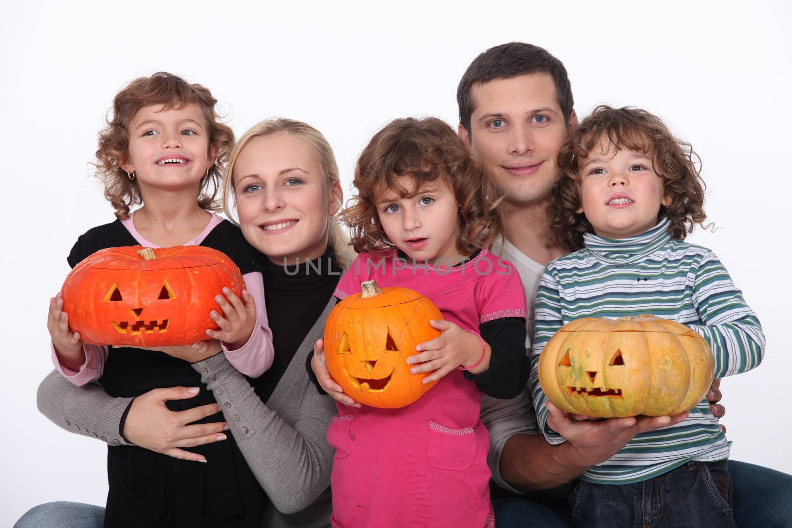 Family with carved pumpkins by phovoir