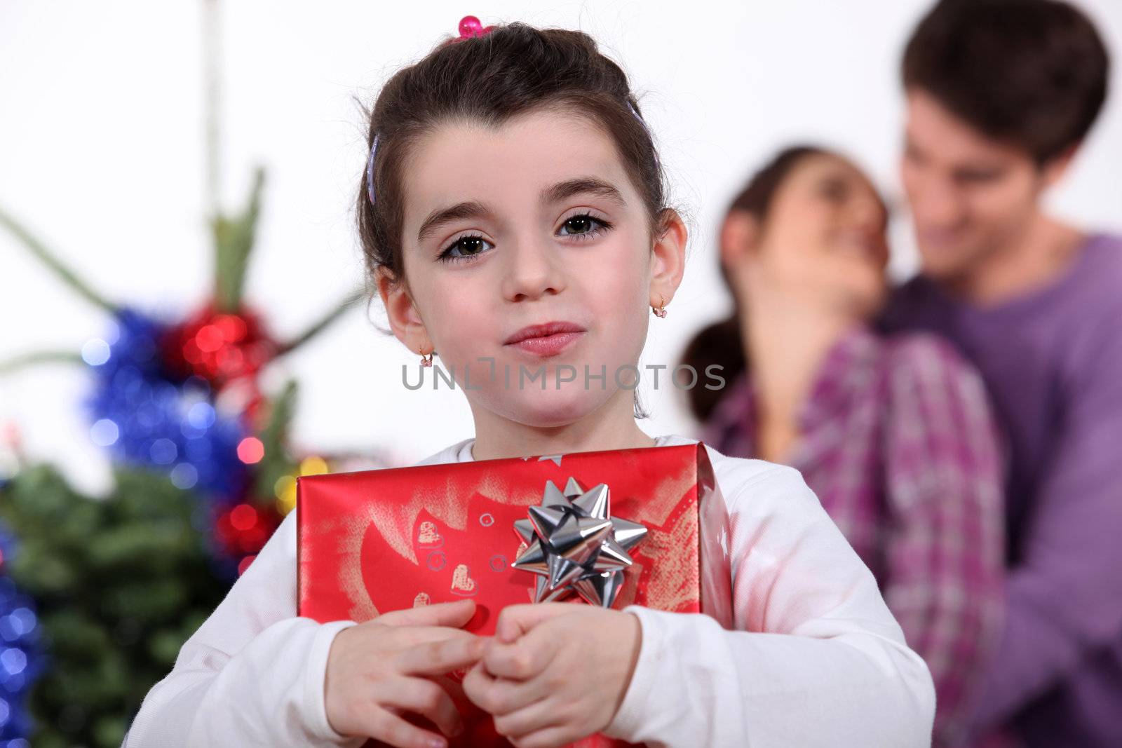 Young girl holding a gift on Christmas Day