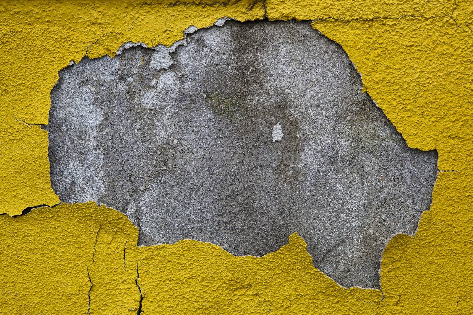Old wall with dirty broken weathered yellow paint