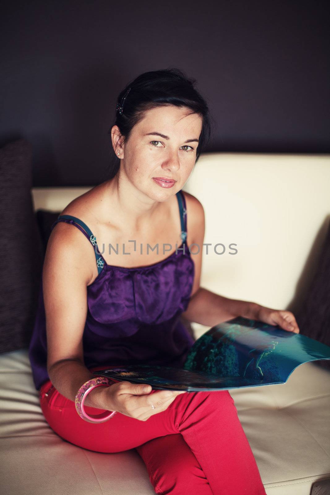  woman read magazine on sofa in living room